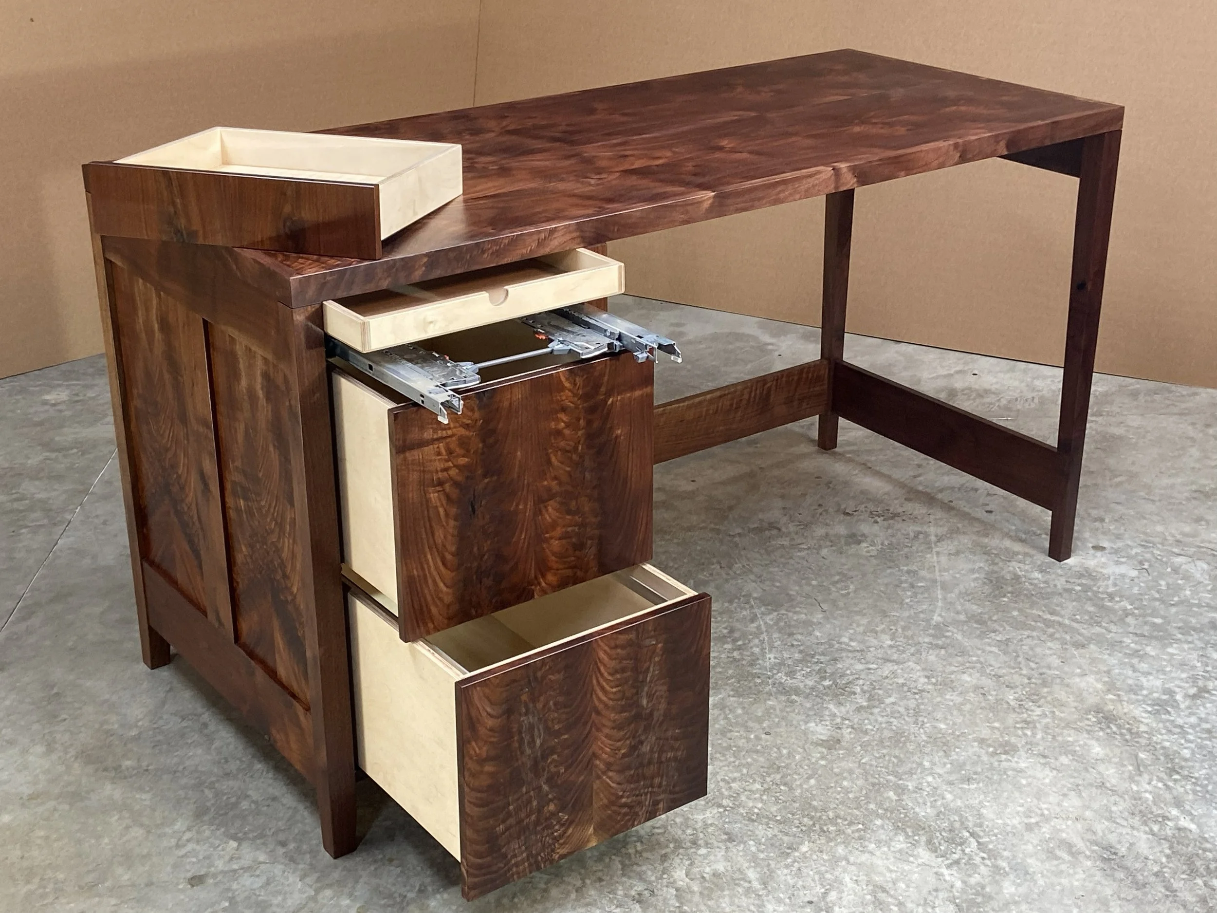 He requested that a secret compartment be integrated into the design. It is accessed by removing the top flat drawer, then pulling out the secret drawer from the back.