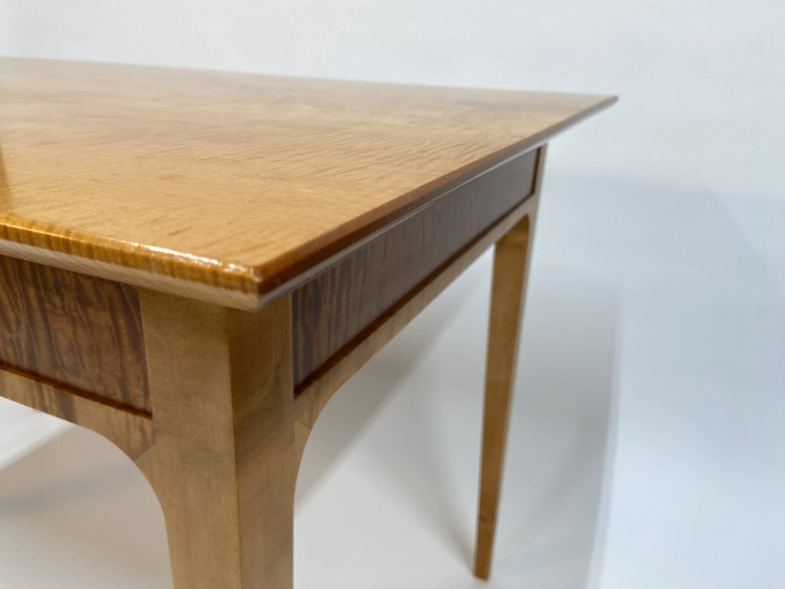 The piece is finished with shellac, while the top is given a lacquer finish for added durability