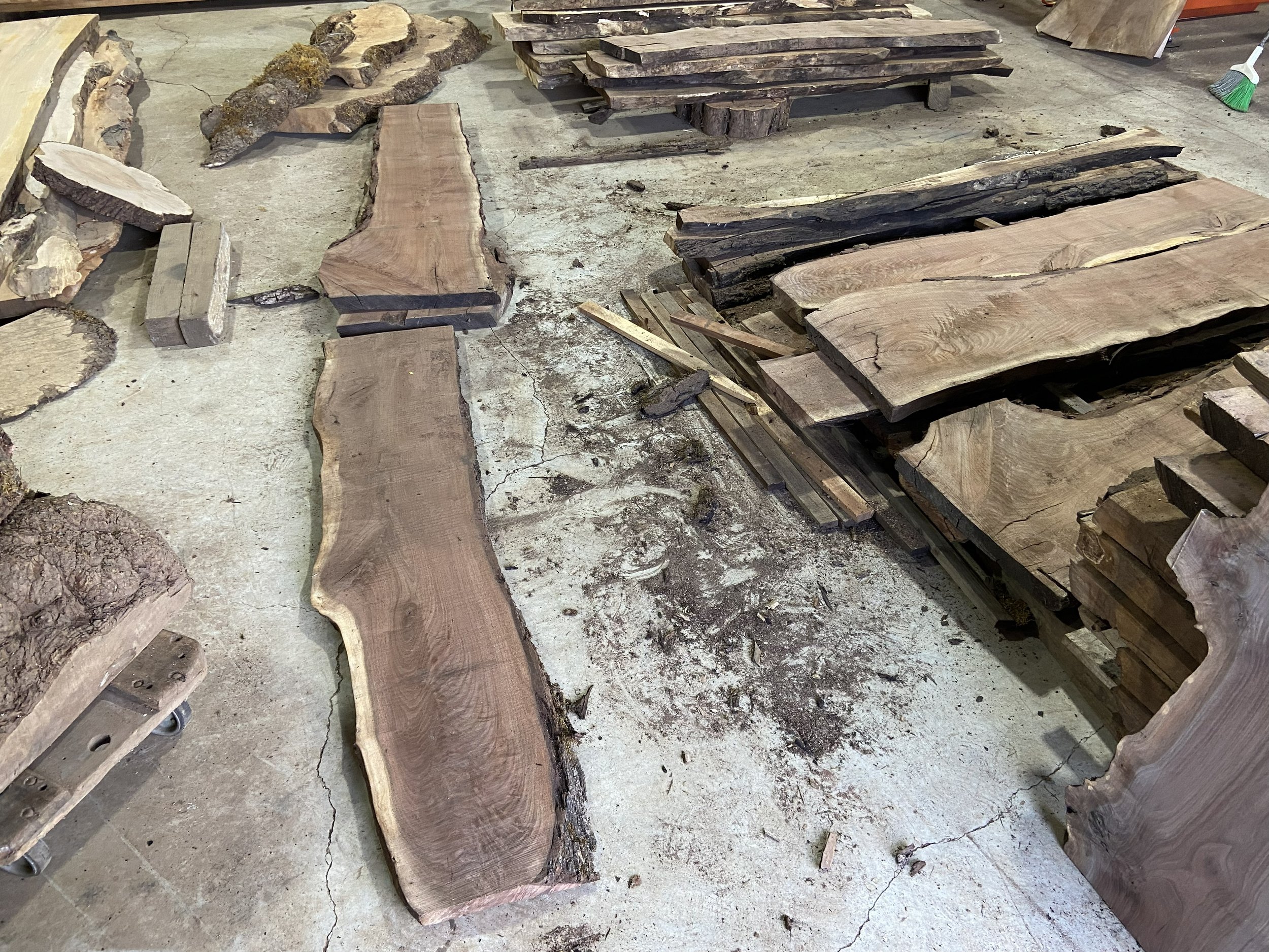 I visited a small Oregon lumber mill and found beautiful Walnut planks with spectacular figure. You can likely see the drawer front's grain in the plank in the foreground.