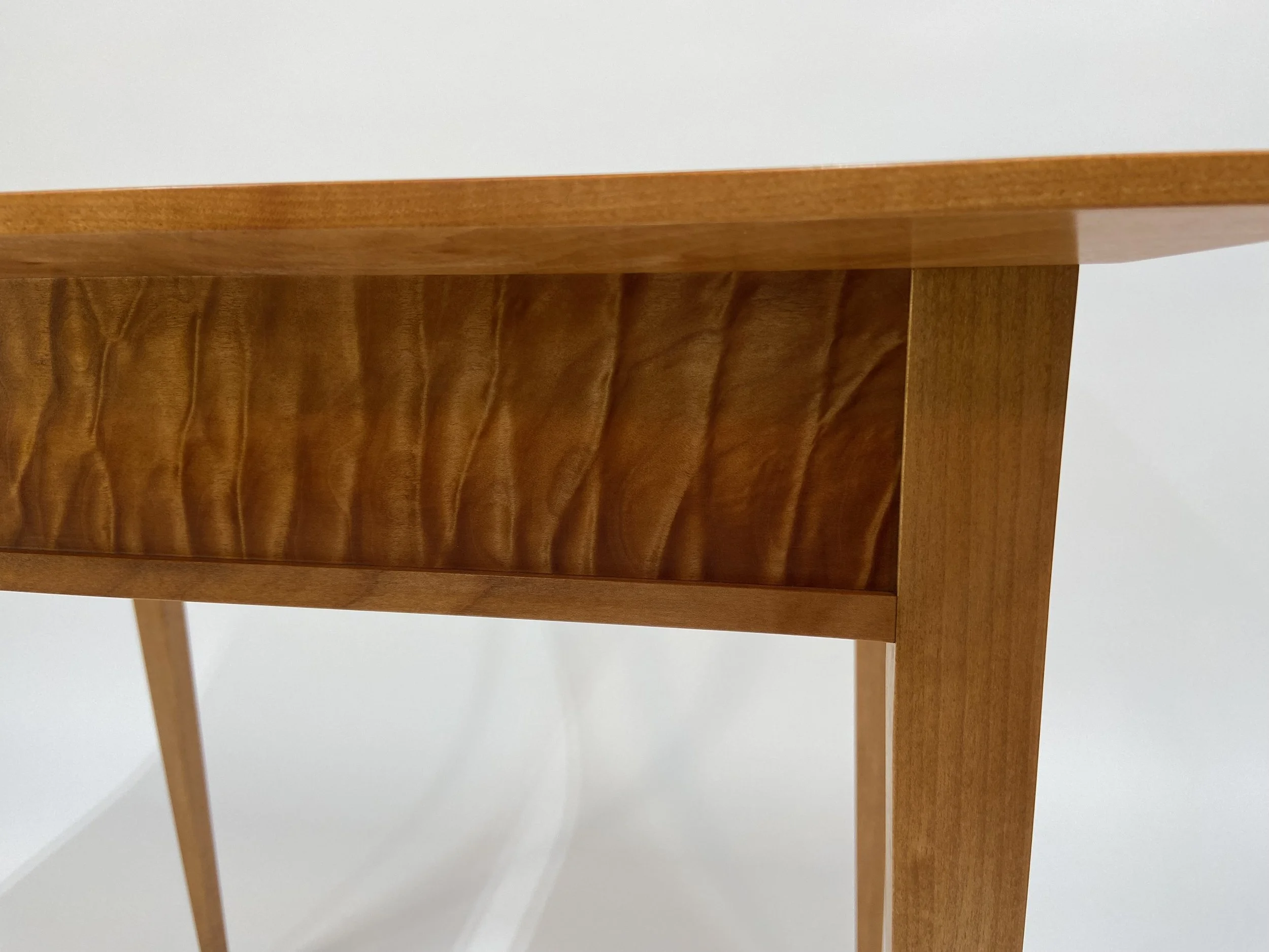 The 7/8 in. thick top is beveled underneath to give a lightness to the sturdy top