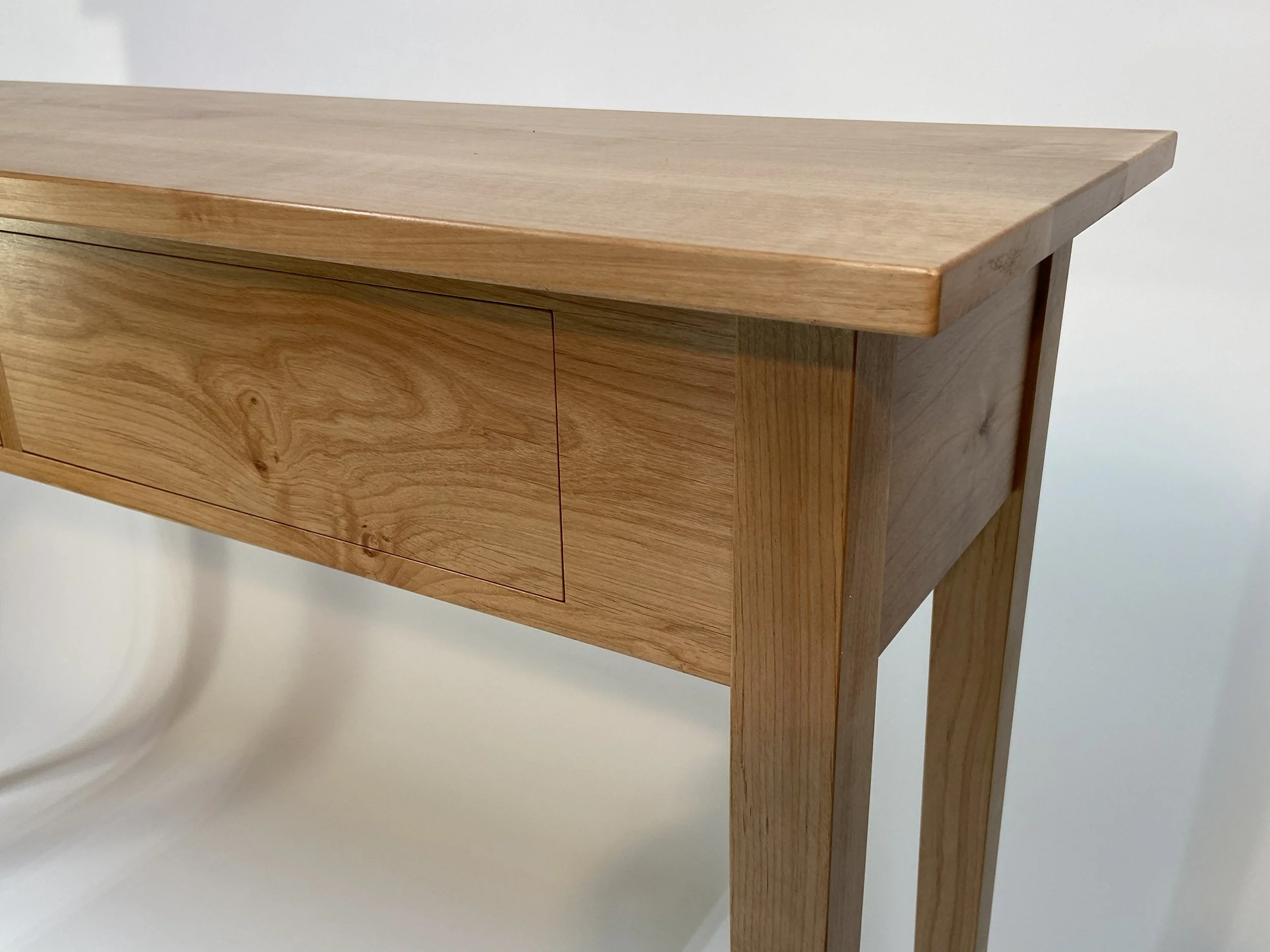 The grain flows from the drawer fronts across to the face