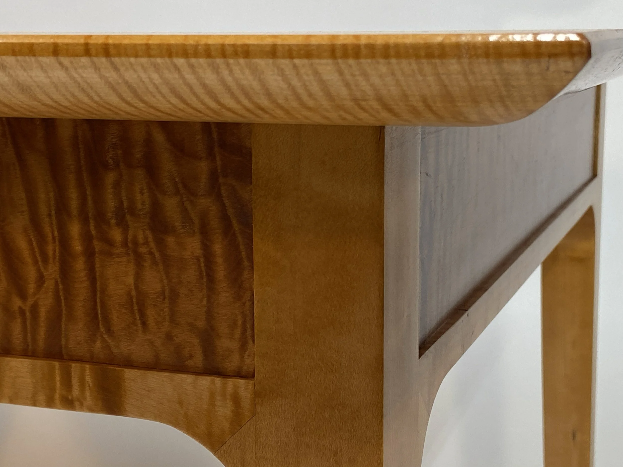 The 1 in. thick top has a chamfer along the top edge, and is rounded underneath to give a lightness to the sturdy top