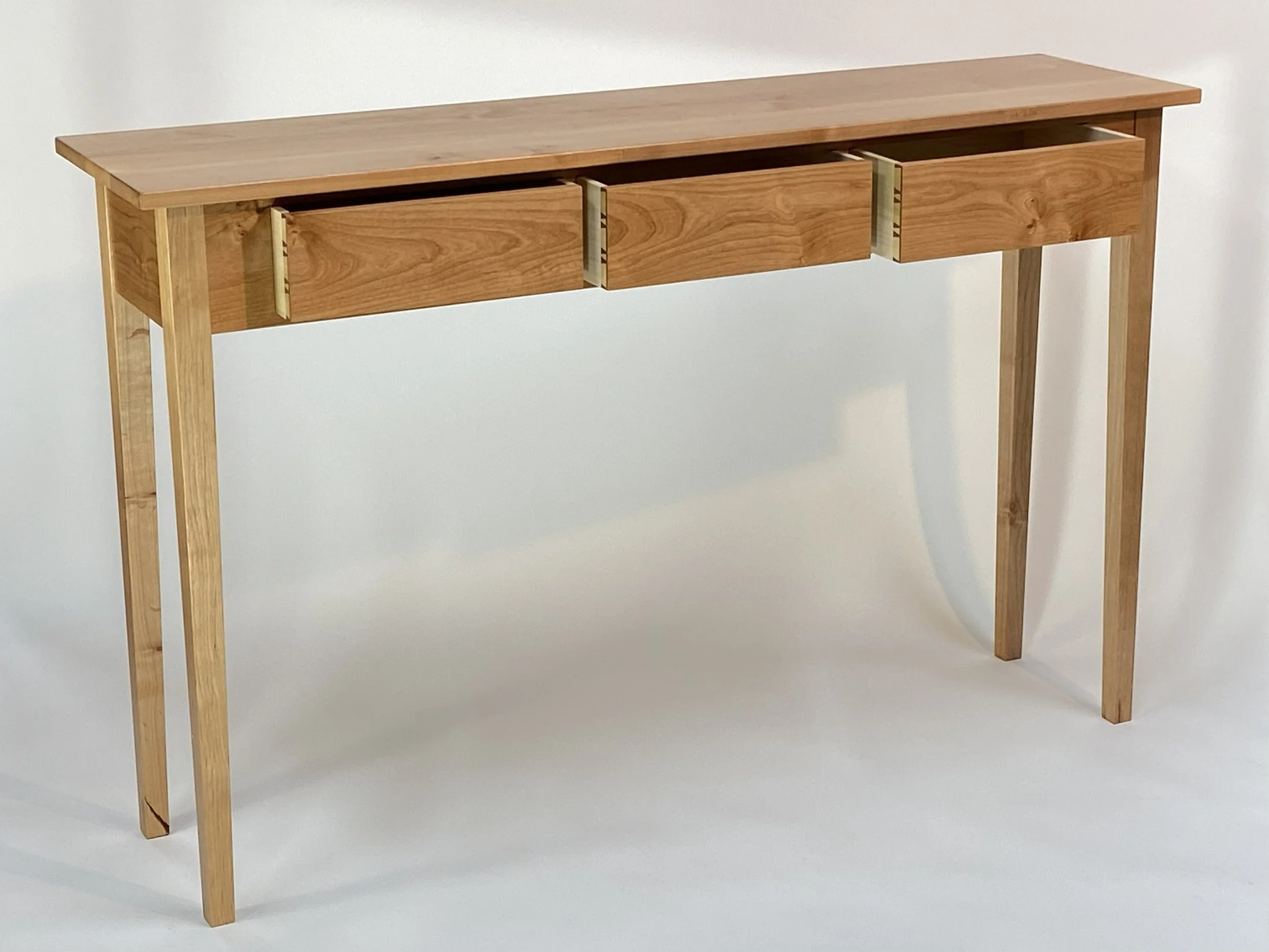 The table features three (3) drawers