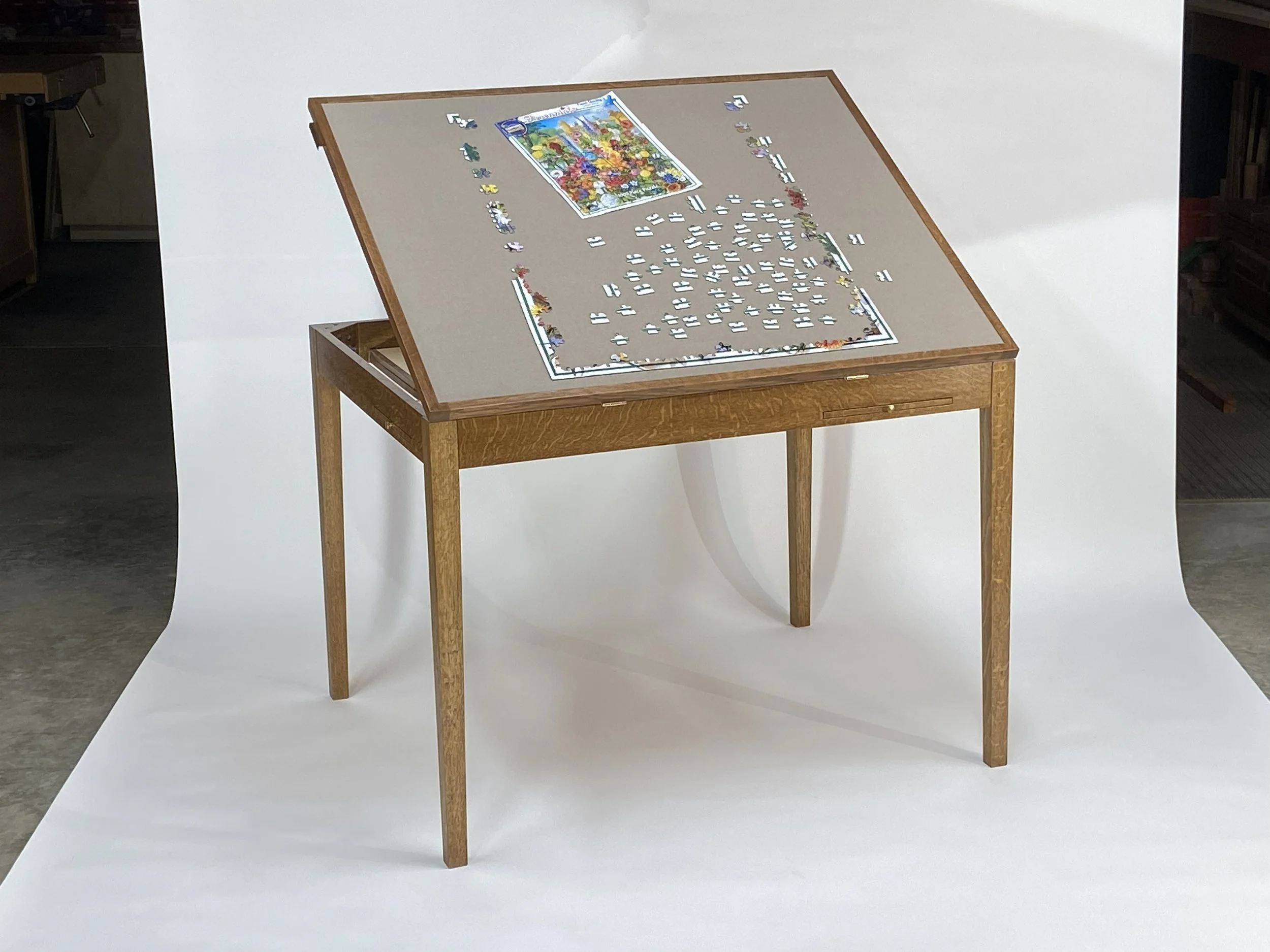 The jigsaw puzzle area is 39" wide x 31" deep, large enough for most puzzles up to 2,000 pieces. The table tilts to a maximum of 30-degrees.