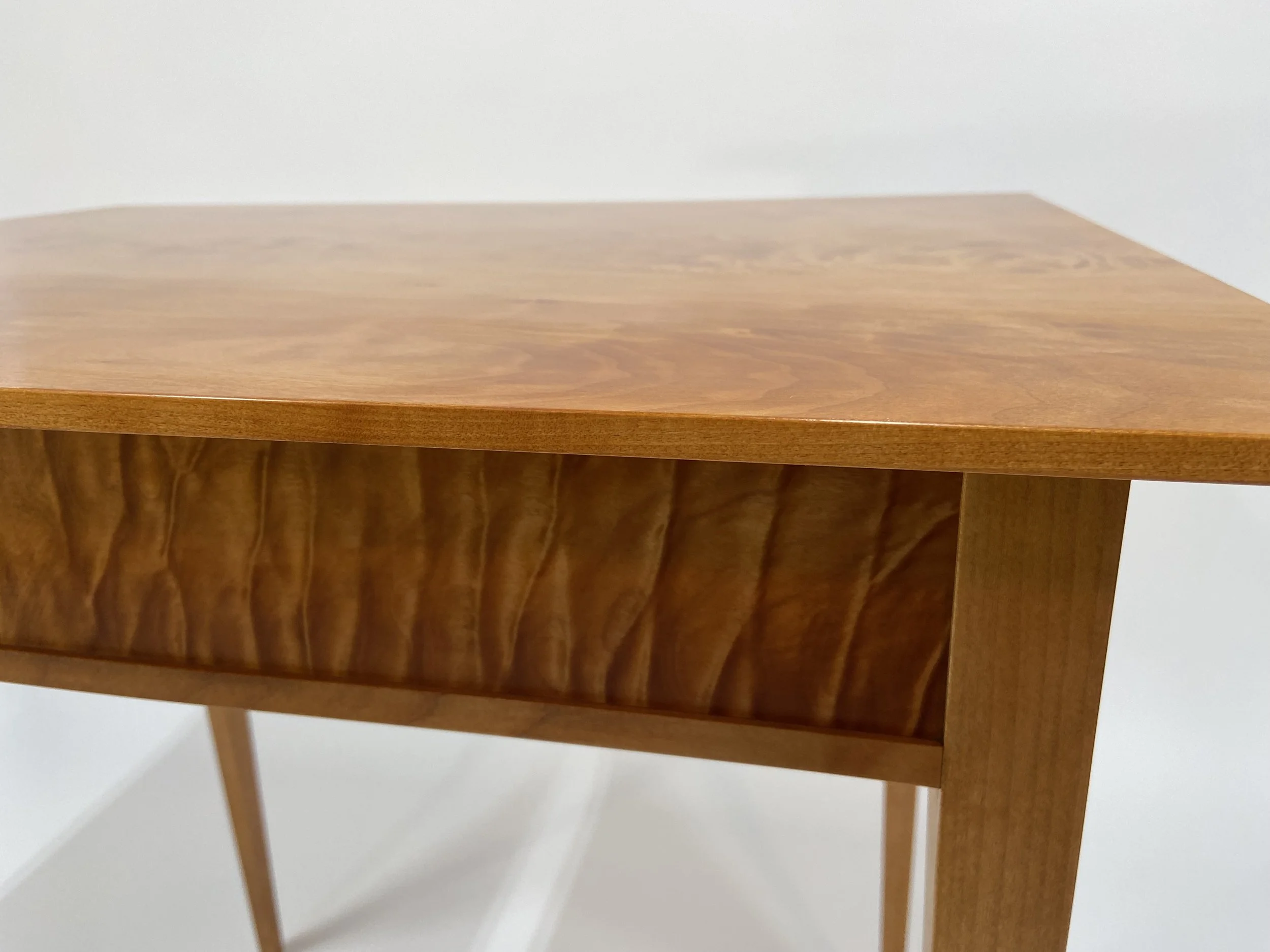 The piece is finished with shellac, while the top is given a lacquer finish for added durability