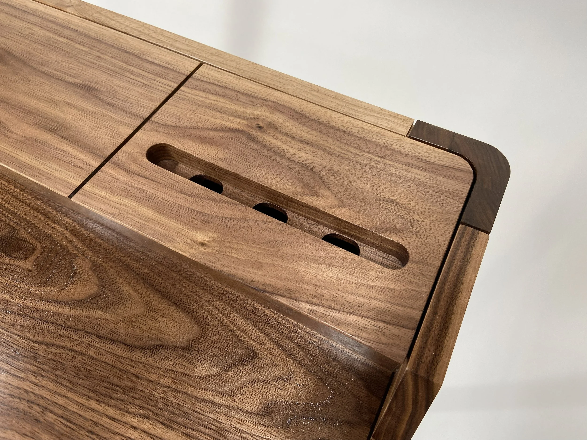 The rear deck has slots to accommodate power cords for phones and tablets