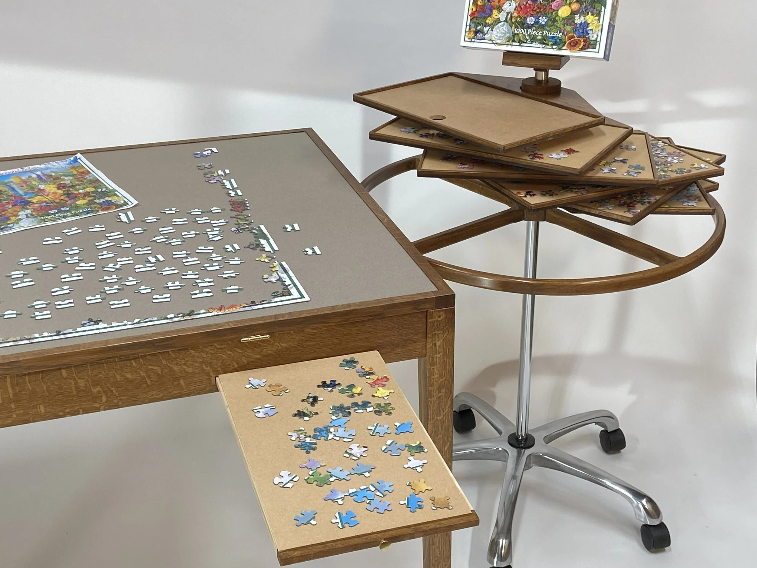 Each of the seven trays has a lift-out board, only 1/8" thick, to place on the pull-out shelf and assemble parts of the jigsaw puzzle before transferring it to the main puzzle area.