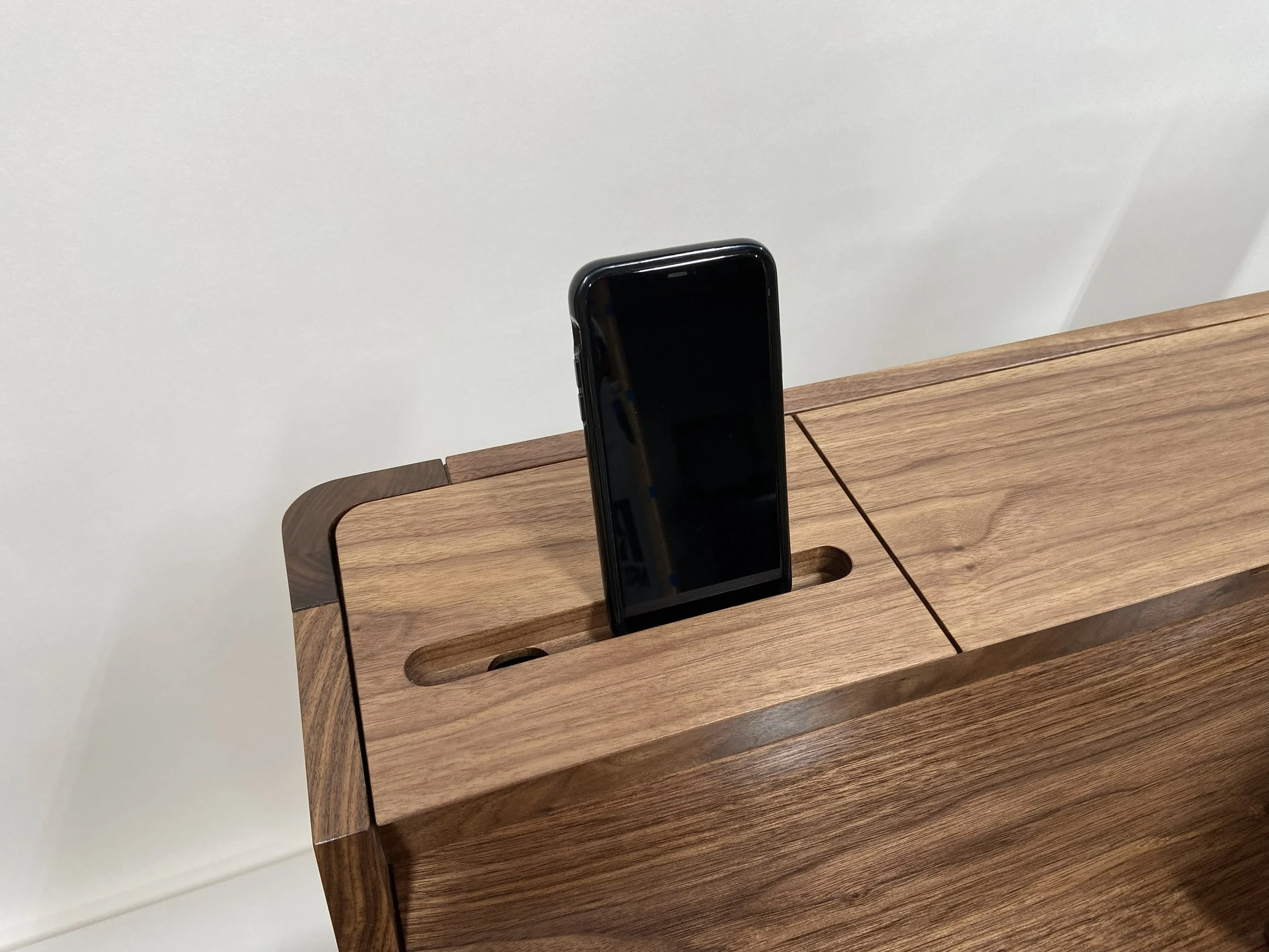 The rear storage compartment lid holds a phone ...