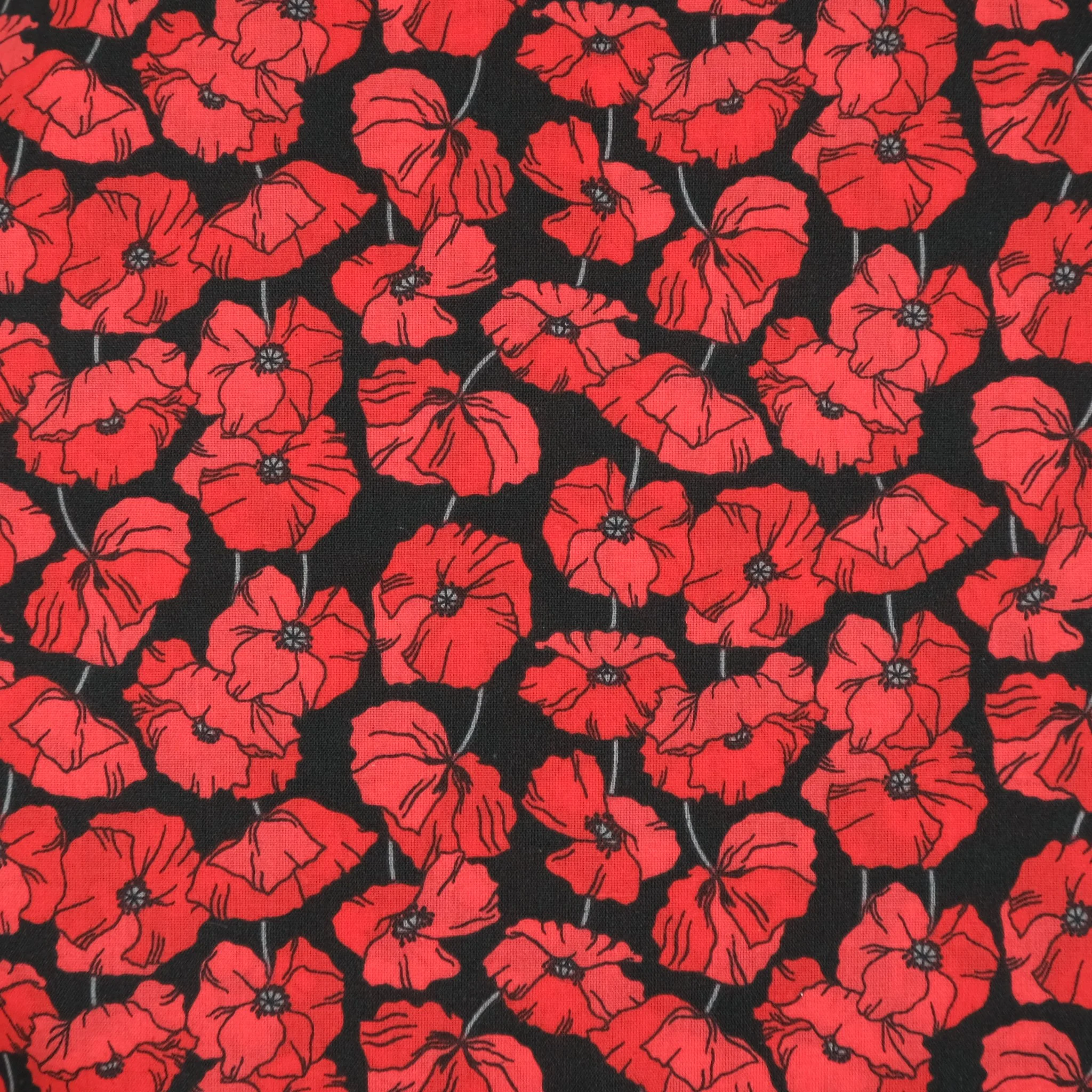 Black fabric with red poppies, used for handmade Axis Range scrunchie by Creatoria Nyx