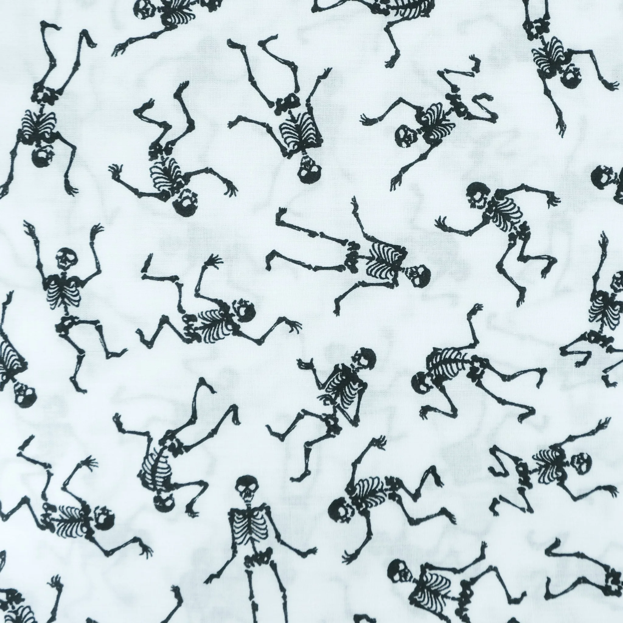 Fabric close up showing dancing skeletons on white background, used for handmade Axis Range scrunchie by Creatoria Nyx