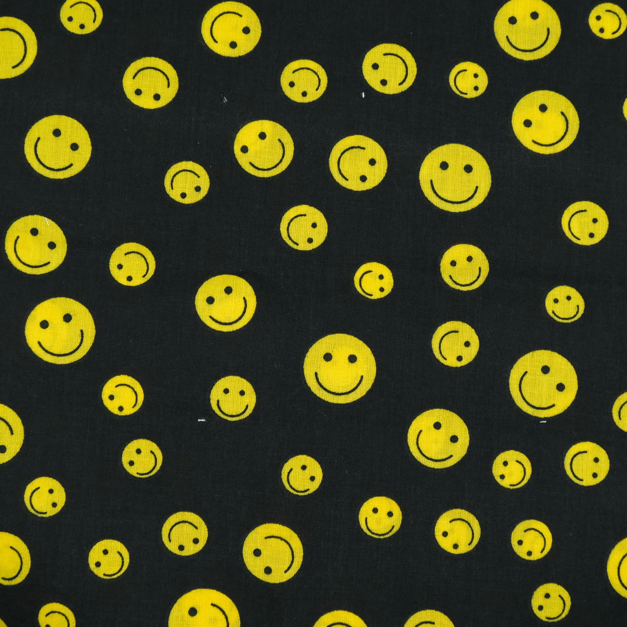Black fabric with yellow smiley pattern, used for handmade Axis Range scrunchie by Creatoria Nyx