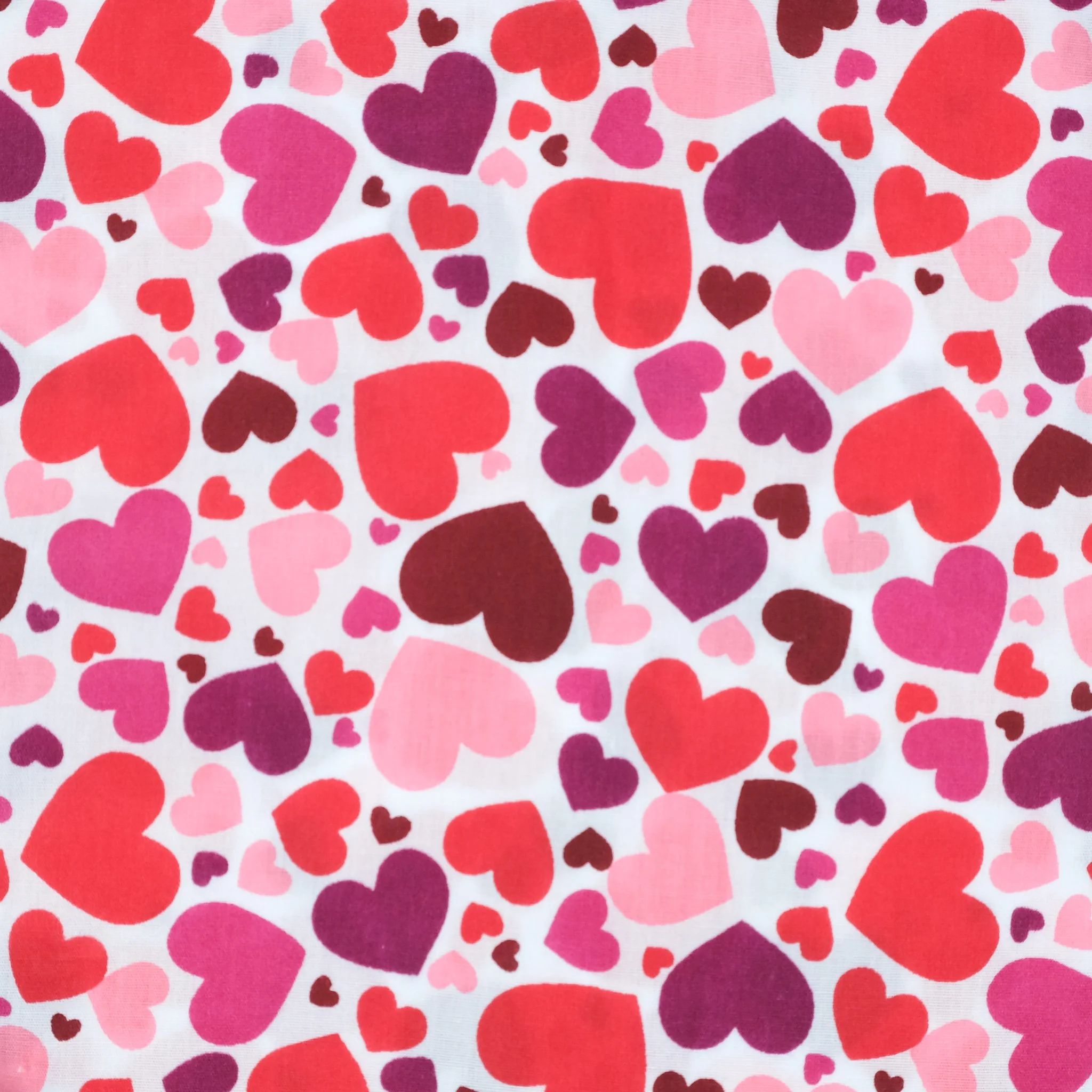 White fabric with hearts in reds and pinks, used for handmade Axis Range scrunchie by Creatoria Nyx
