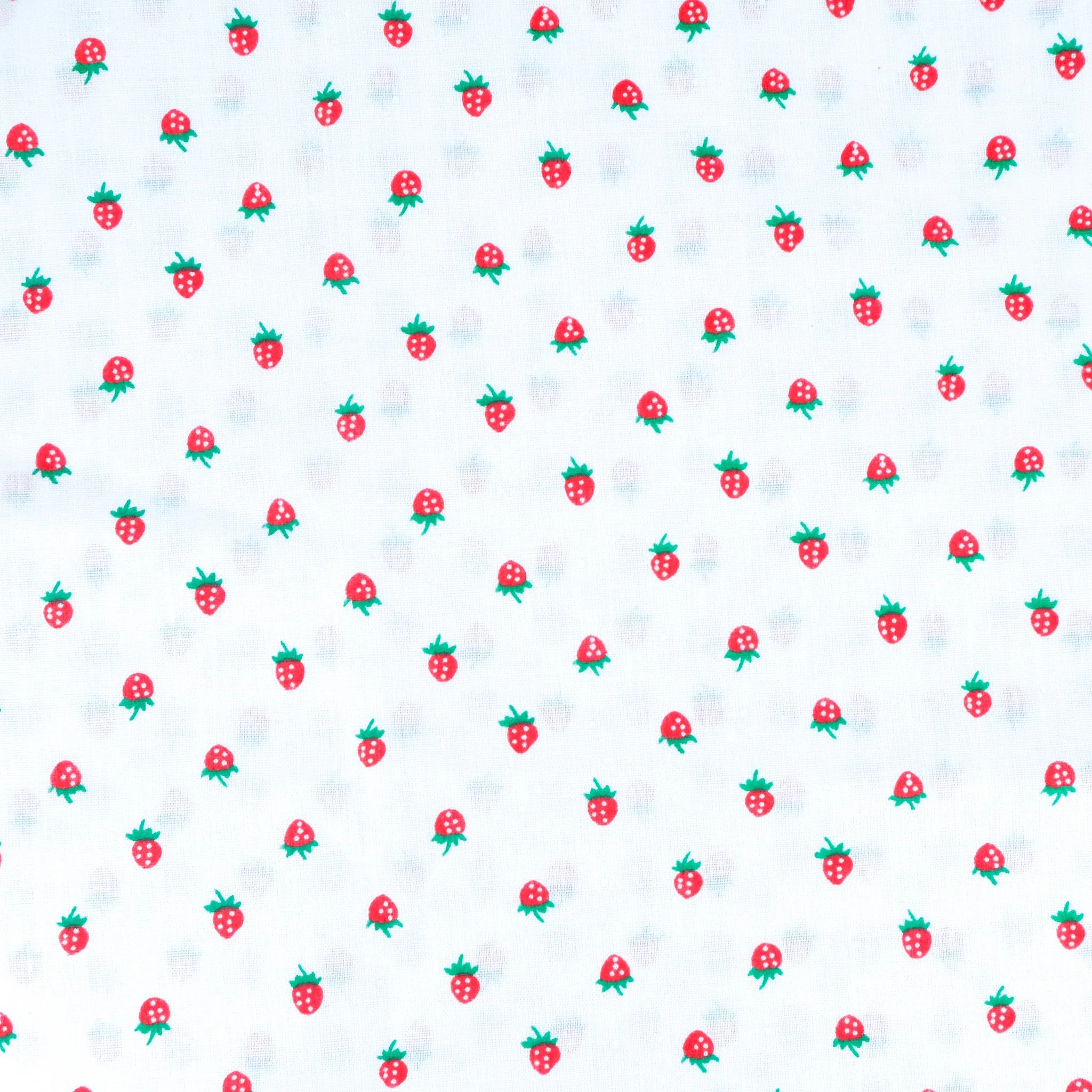 Fabric close up showing tiny red strawberries on white background, used for handmade Axis Range scrunchie by Creatoria Nyx