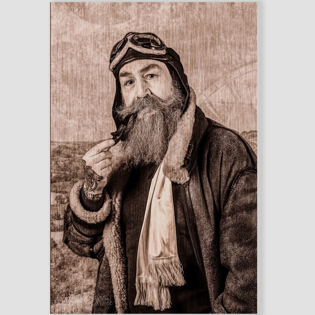 Square thumbnail of notebook front cover with bearded aviator in leather cap, goggles, and shearling jacket holding a pipe