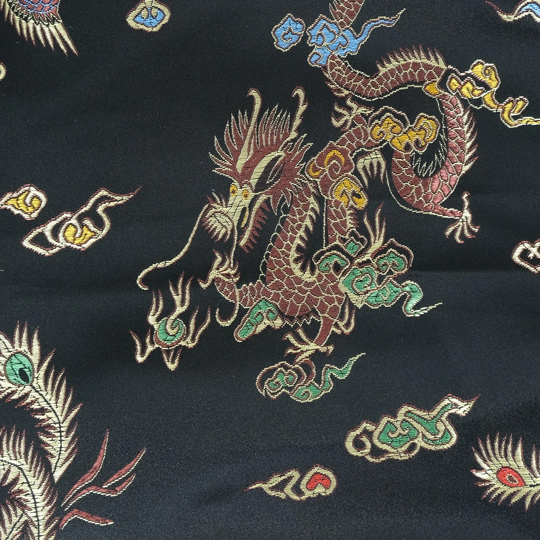 Fabric close up showing gold Chinese dragons on black satin background, used for handmade Axis Range scrunchie by Creatoria Nyx