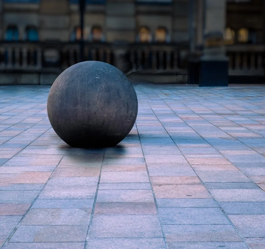 Stone Ball Photo Walks Photography by Catherine Knee. Large stone sphere sculpture resting on patterned paving in Birmingham city centre, creating a minimalist urban architectural composition.