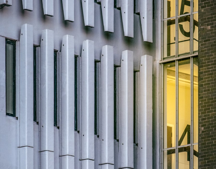 Repeating concrete supports and layered architectural forms beneath Coventry's ring road, creating depth and geometric patterns.