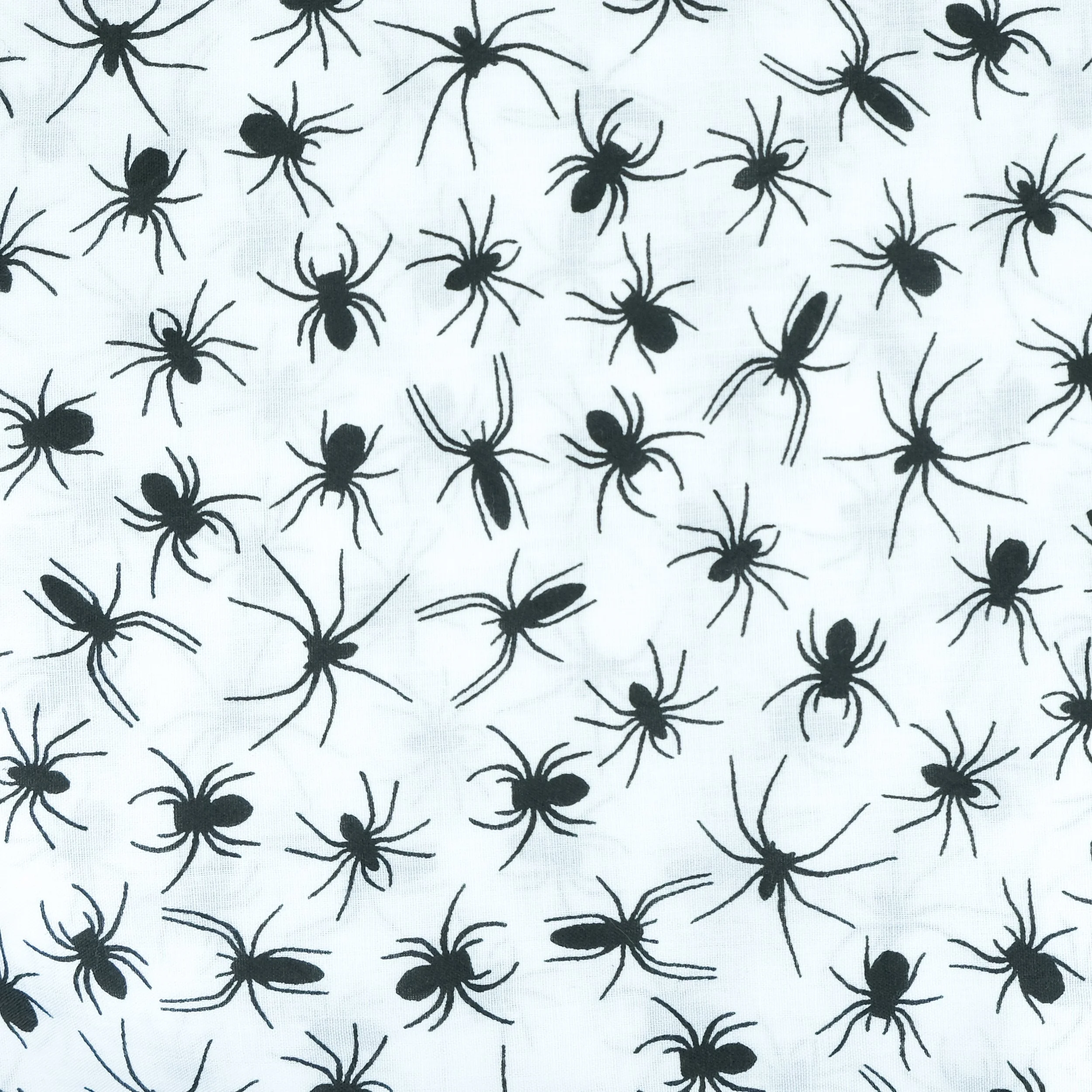 Fabric close up showing black spider silhouettes on white background, used for handmade Axis Range scrunchie by Creatoria Nyx