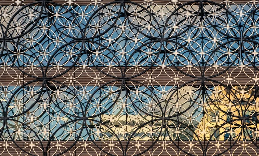 Steel Circles in the Sunset Photo Walks Photography by Catherine Knee. Circular architectural details and reflective glass illuminated by warm evening sunlight in Birmingham city centre.