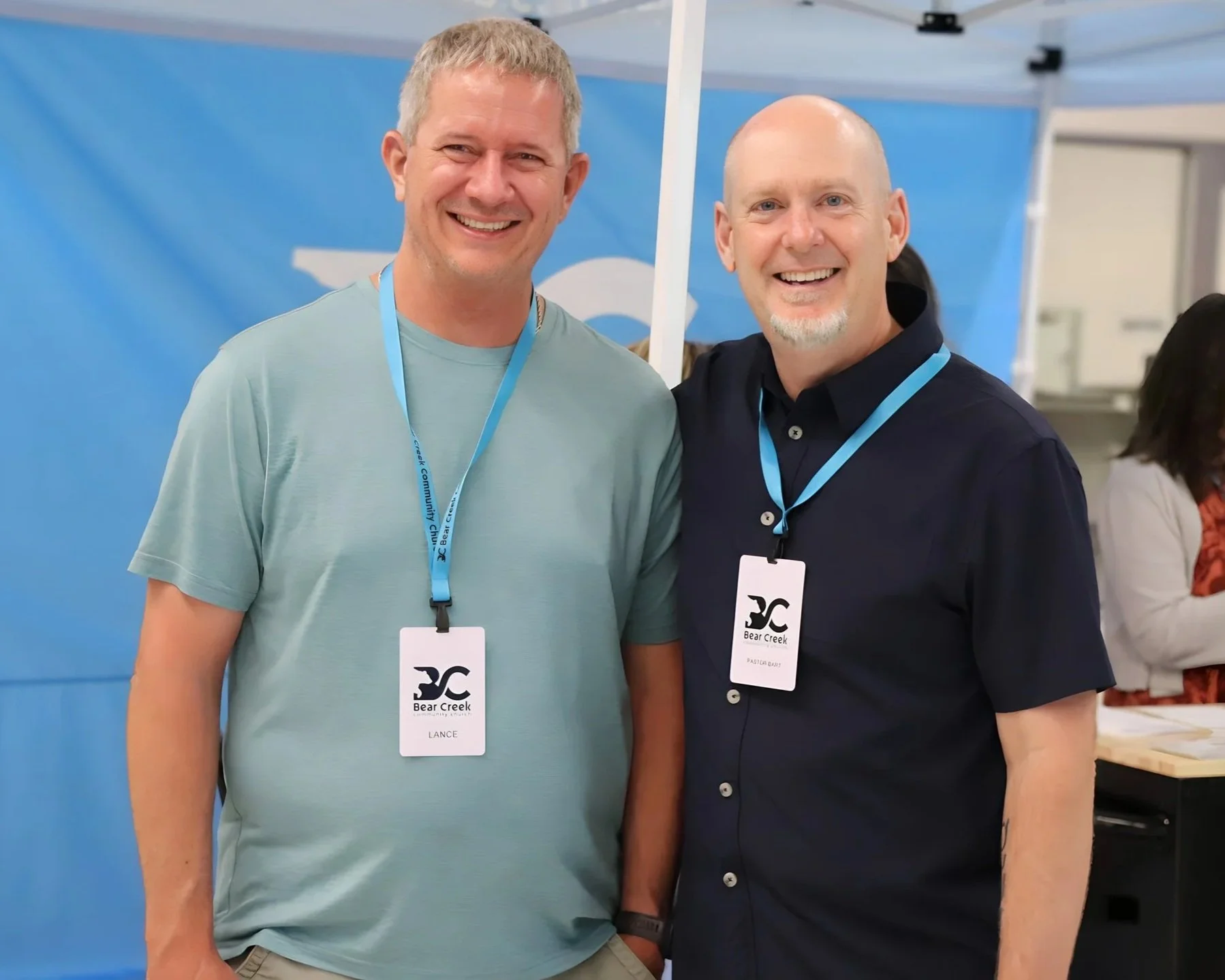 Two men smiling, happy to be at church