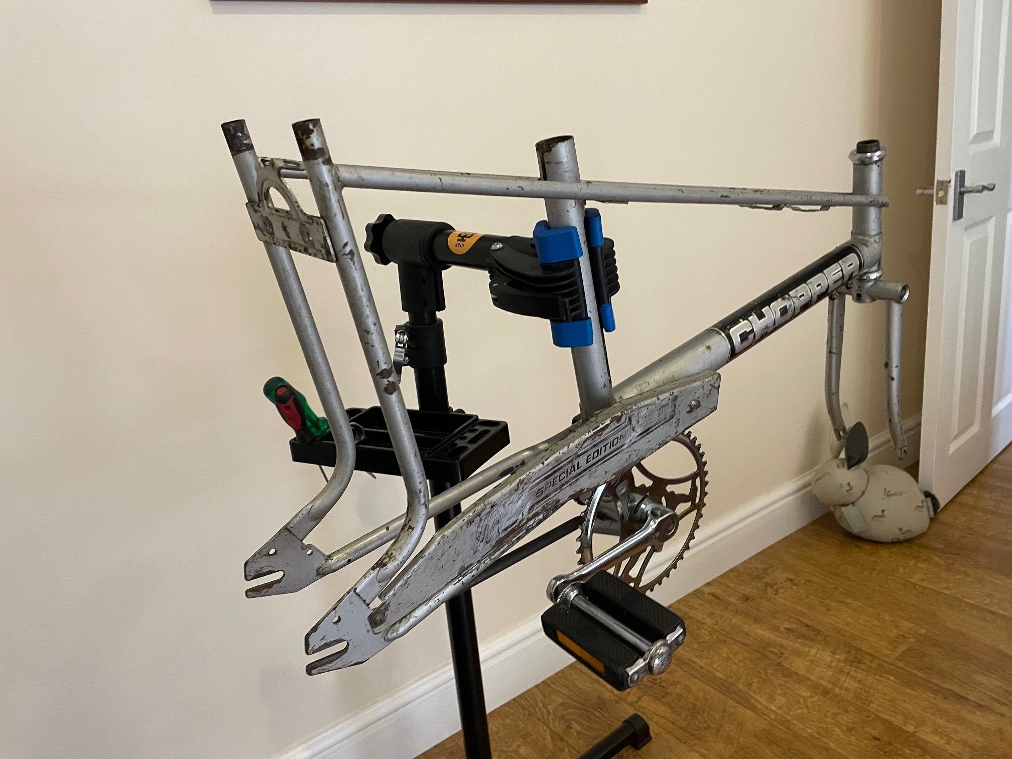 Now inside, the bike is being built up. The original chain guard that came with the bike has been carefully cleaned as it was previously covered in thick black paint. Replacement original forks were needed as the old ones were bent and a fierce groov