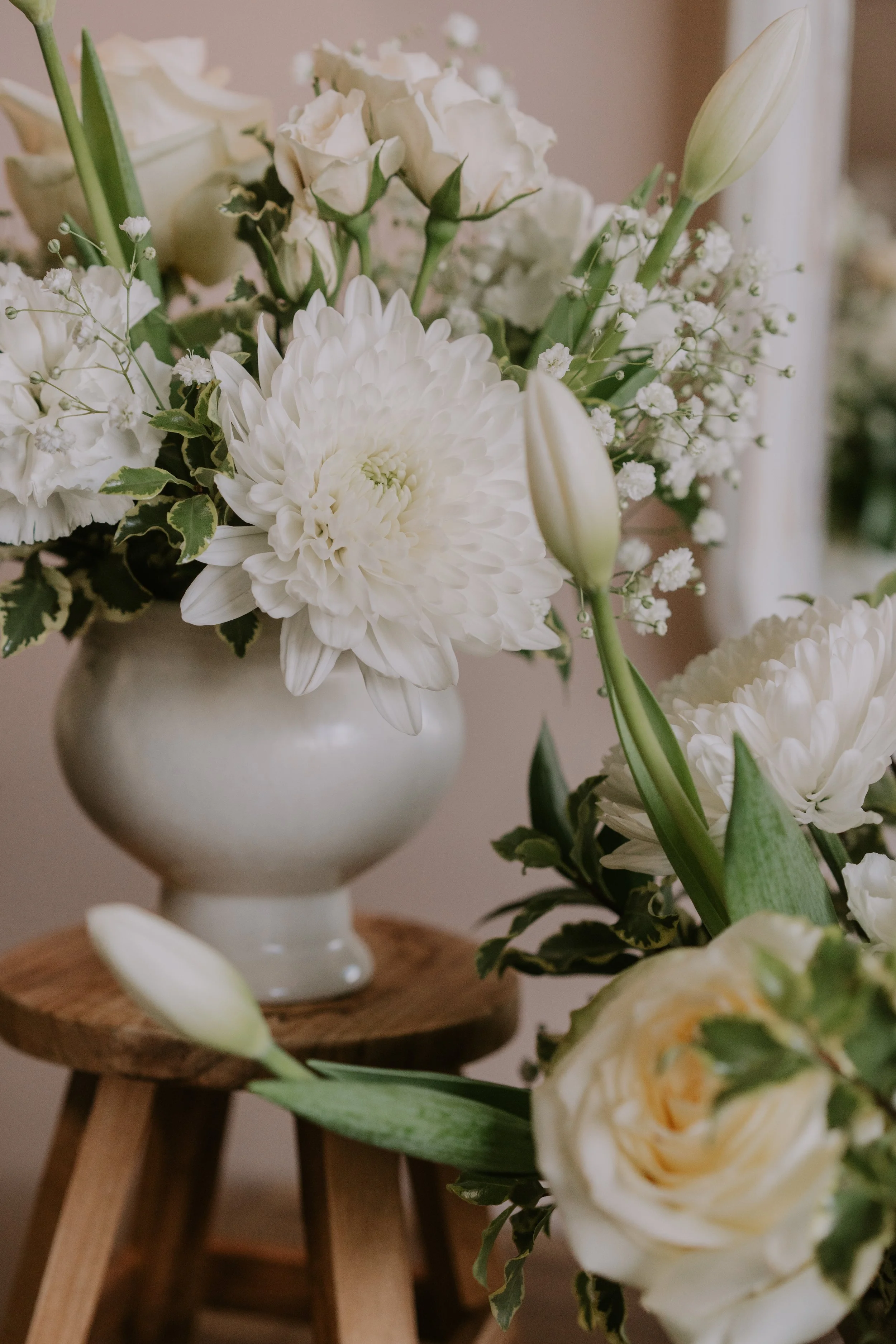 white florals in white vases 