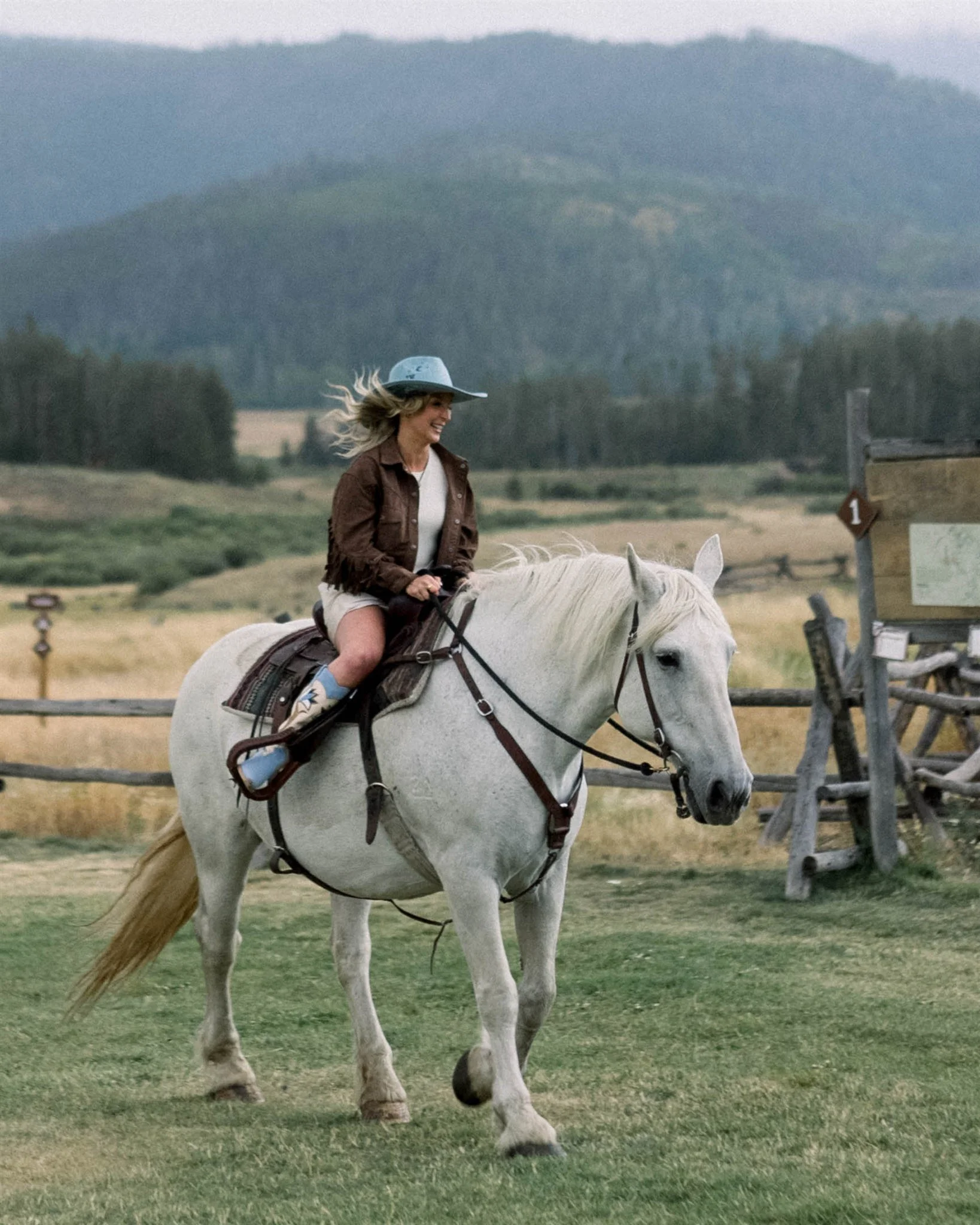 Bride on horseback at Devils Thumb Ranch coming in to their welcome party