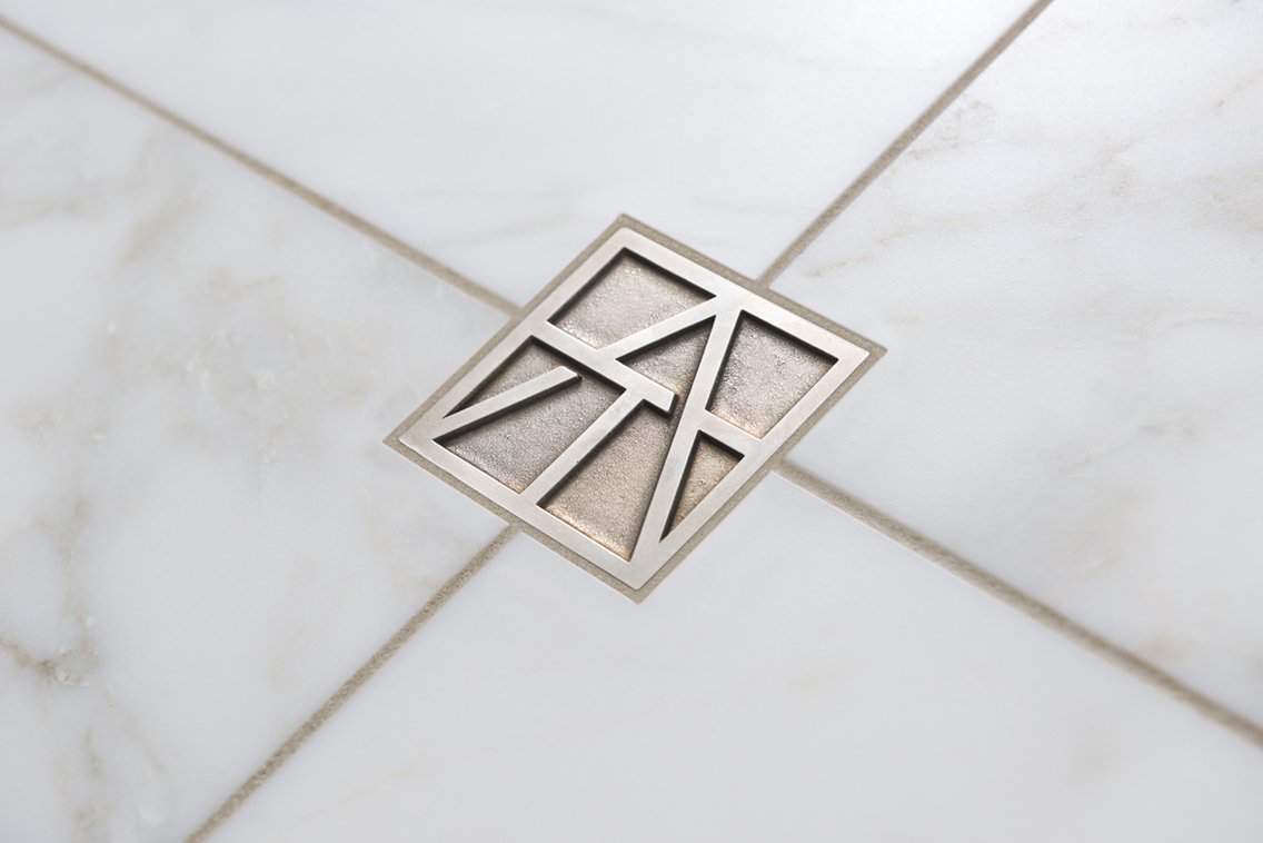ArtisticTile_2015Ad_Logomark_Calacatta.jpg