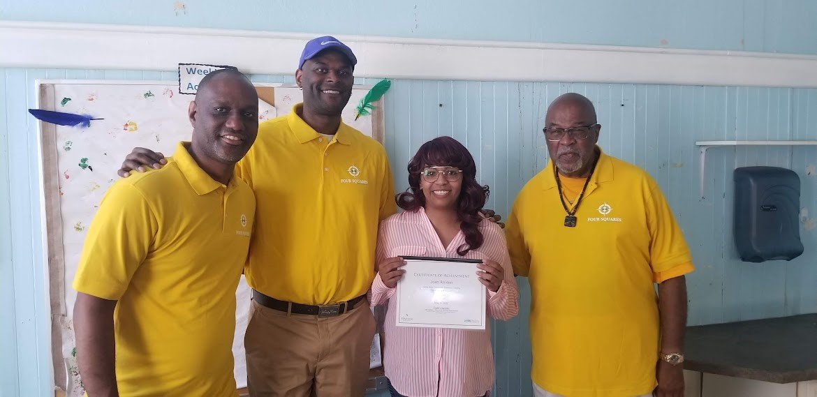 Four Squares York and student with Financial Literacy Certificate.