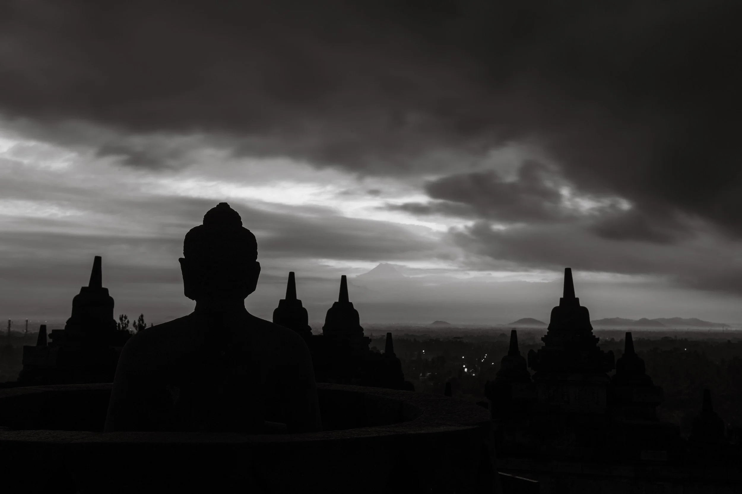Black and white Bagan temple silhouettes under a dark dramatic sky in Myanmar.