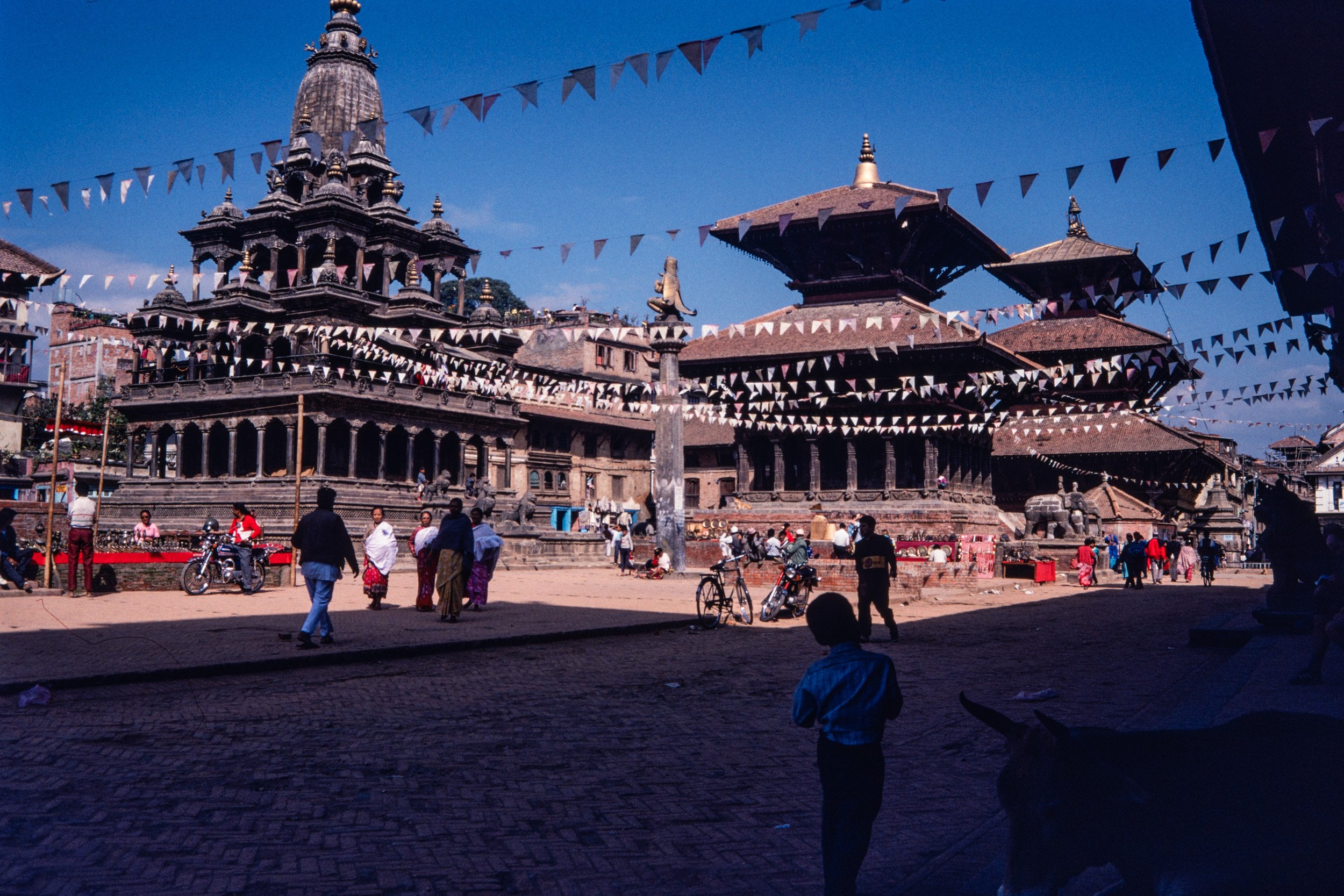 Kathmandu Durbar Square temples and palace architecture with prayer flags in Nepal.