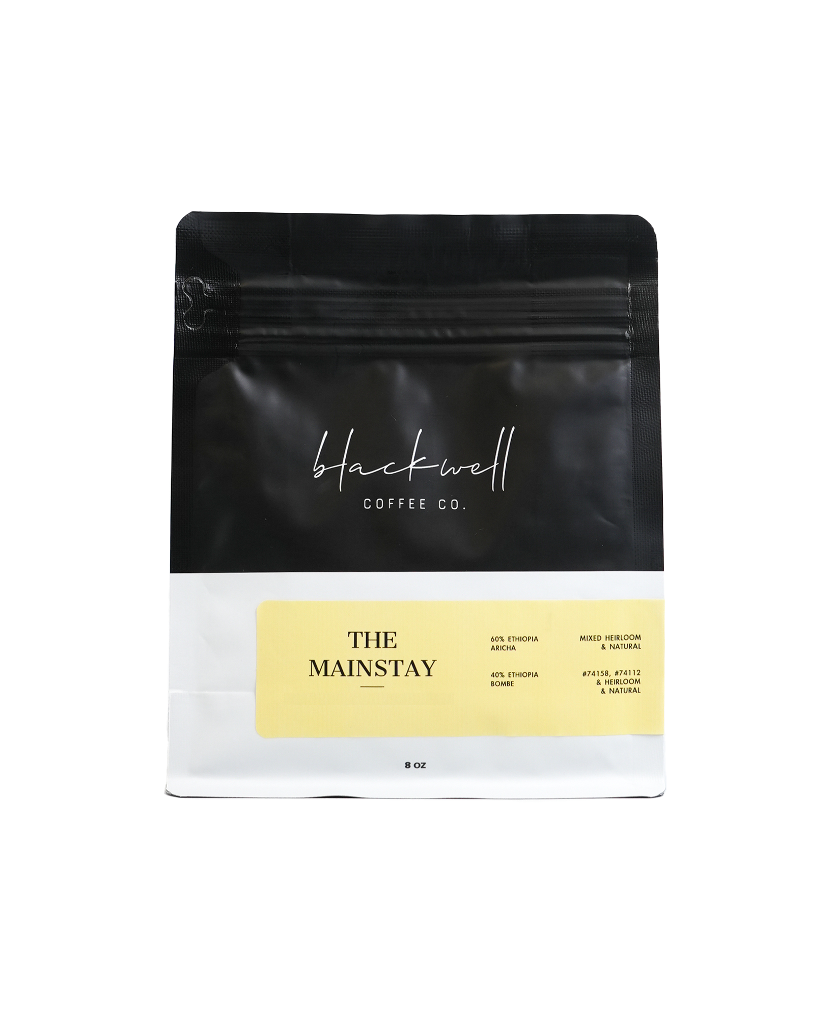 Black coffee bag with white text reading "Hackwell Coffee Co." and a yellow label with black text listing coffee blend details and caffeine content.