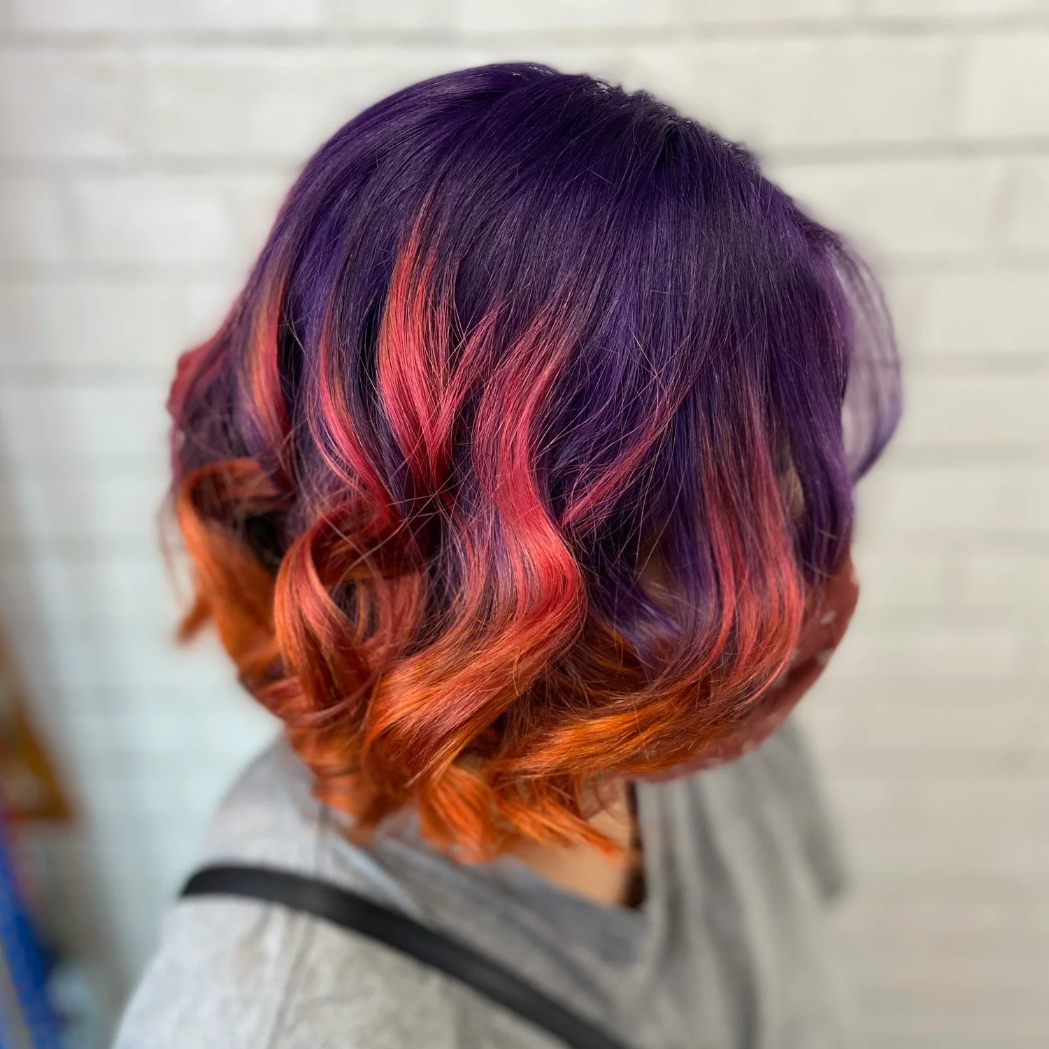 Short bob with purple and orange ombre curls