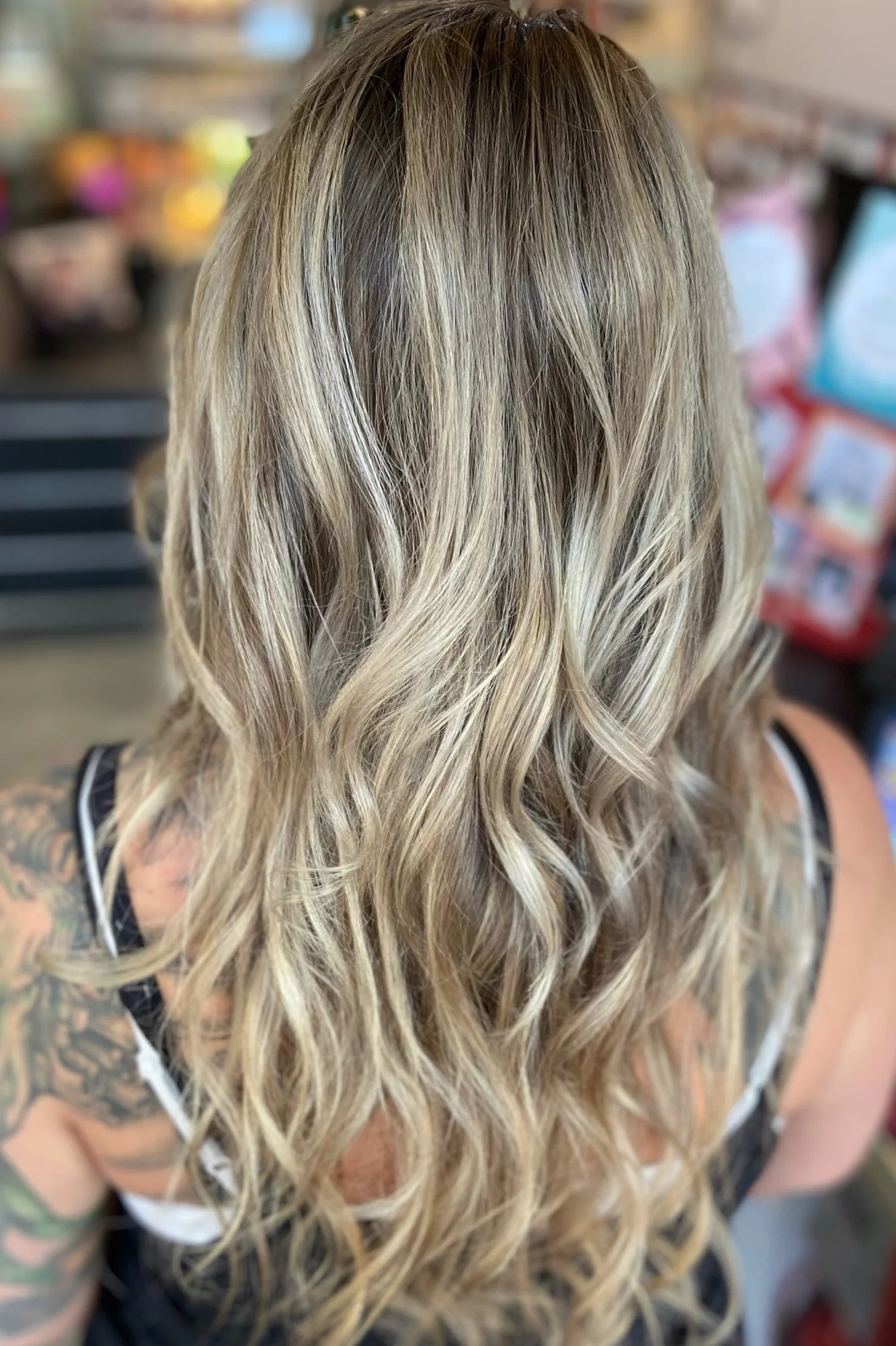 Long blonde balayage with waves seen from behind
