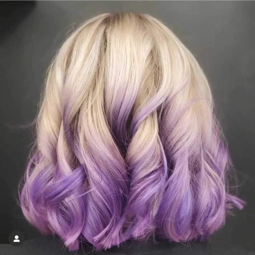 Blonde hair with lavender purple ends in soft waves