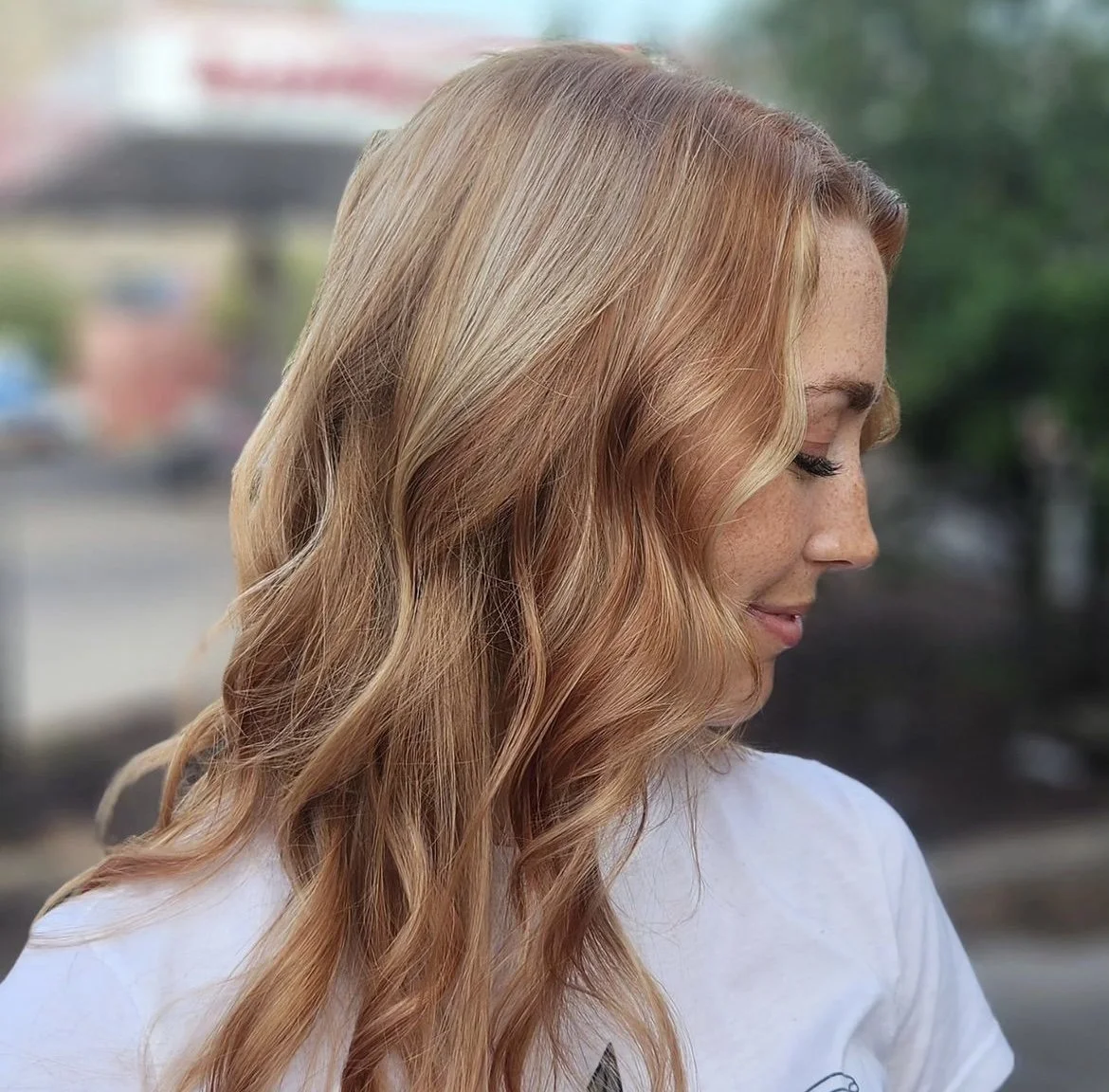 Copper-blonde wavy hair in profile outdoors