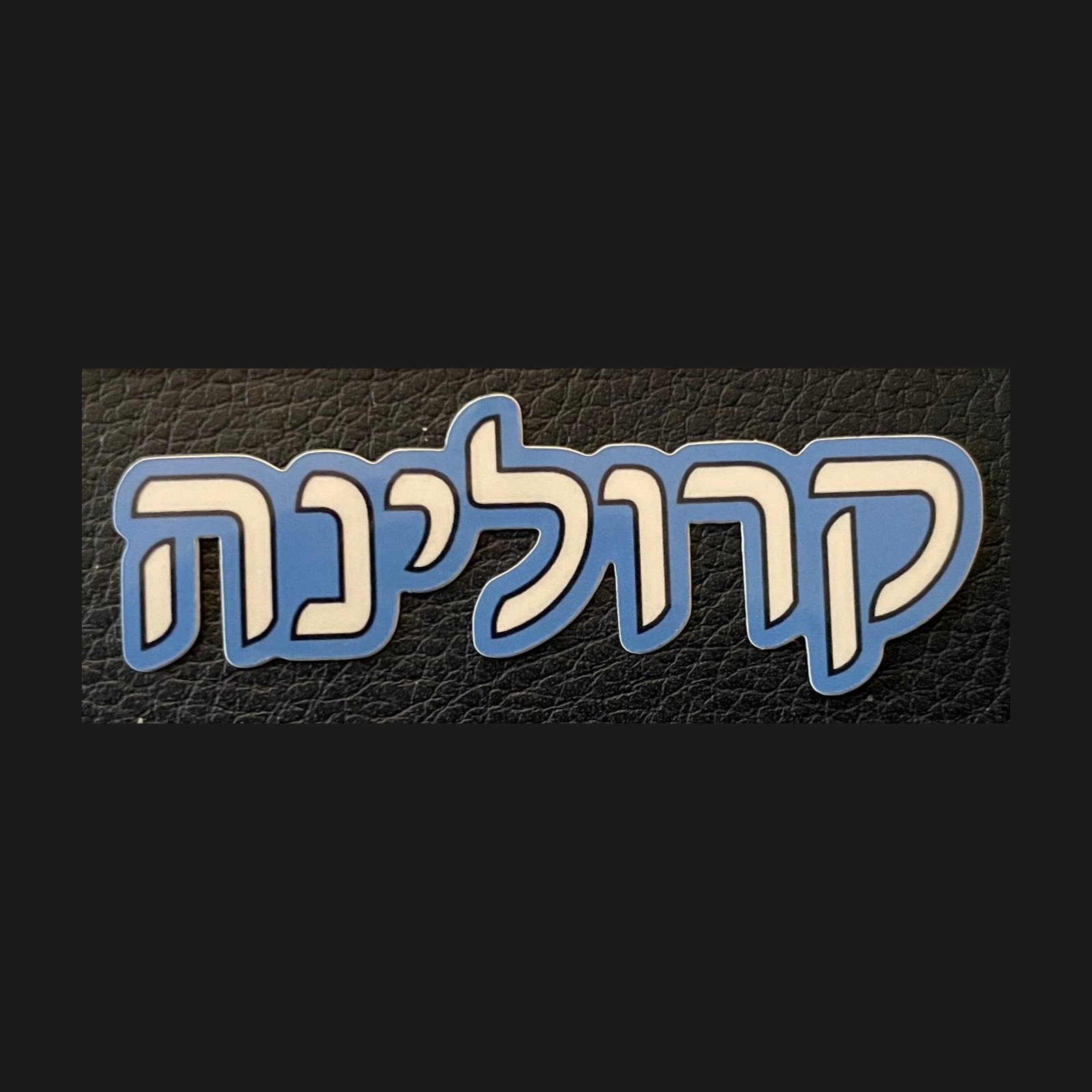 Blue Carolina sticker with white Hebrew lettering on one line.