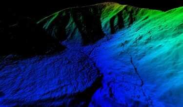 Colorful 3D topographic map of a mountainous terrain with green, blue, and black elevation areas.