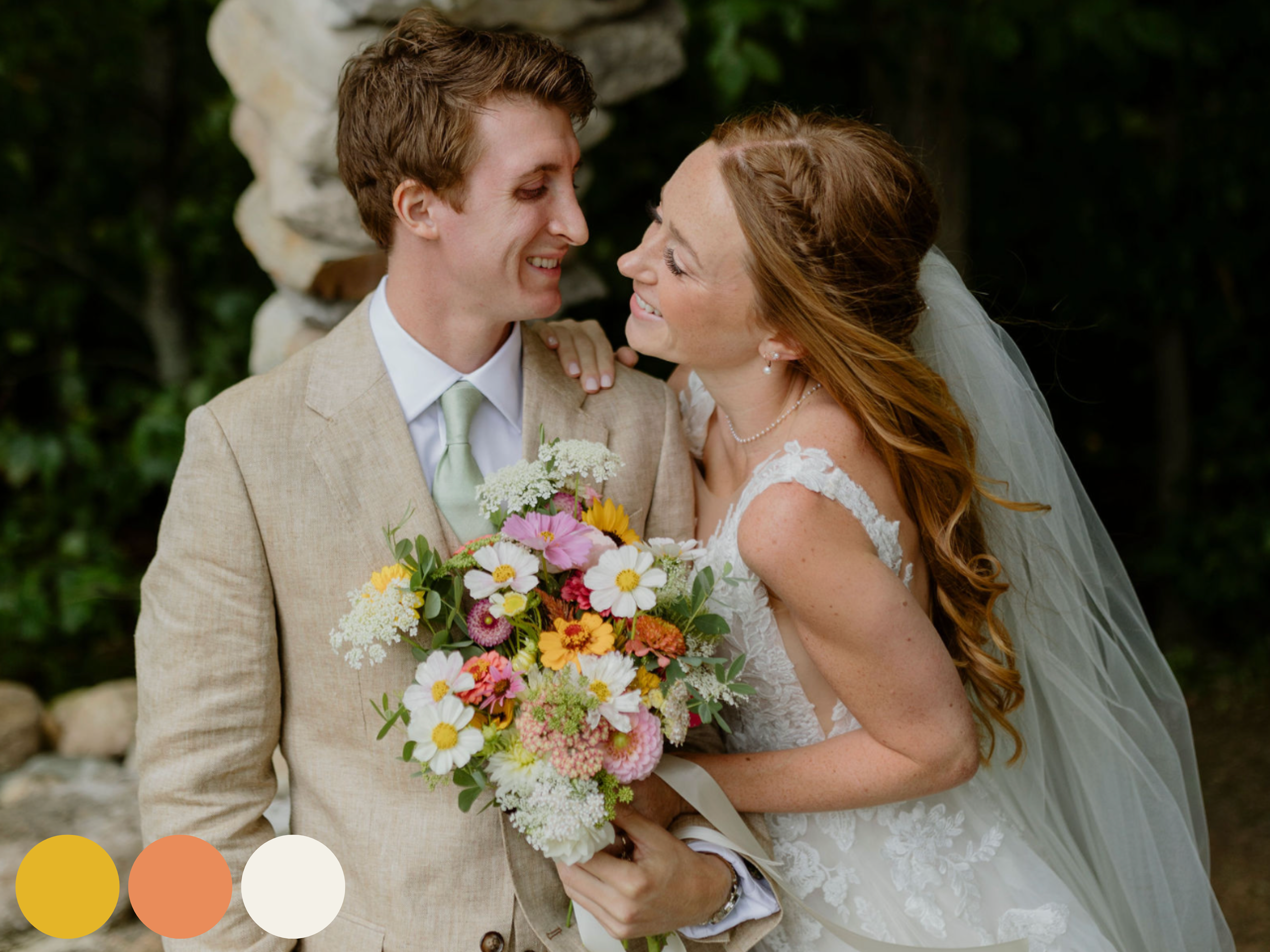 bride and groom embracing outdoors with bouquet featuring summer wedding flowers in an airy summer wedding flower color palette with peach, yellow, pink, and white blooms