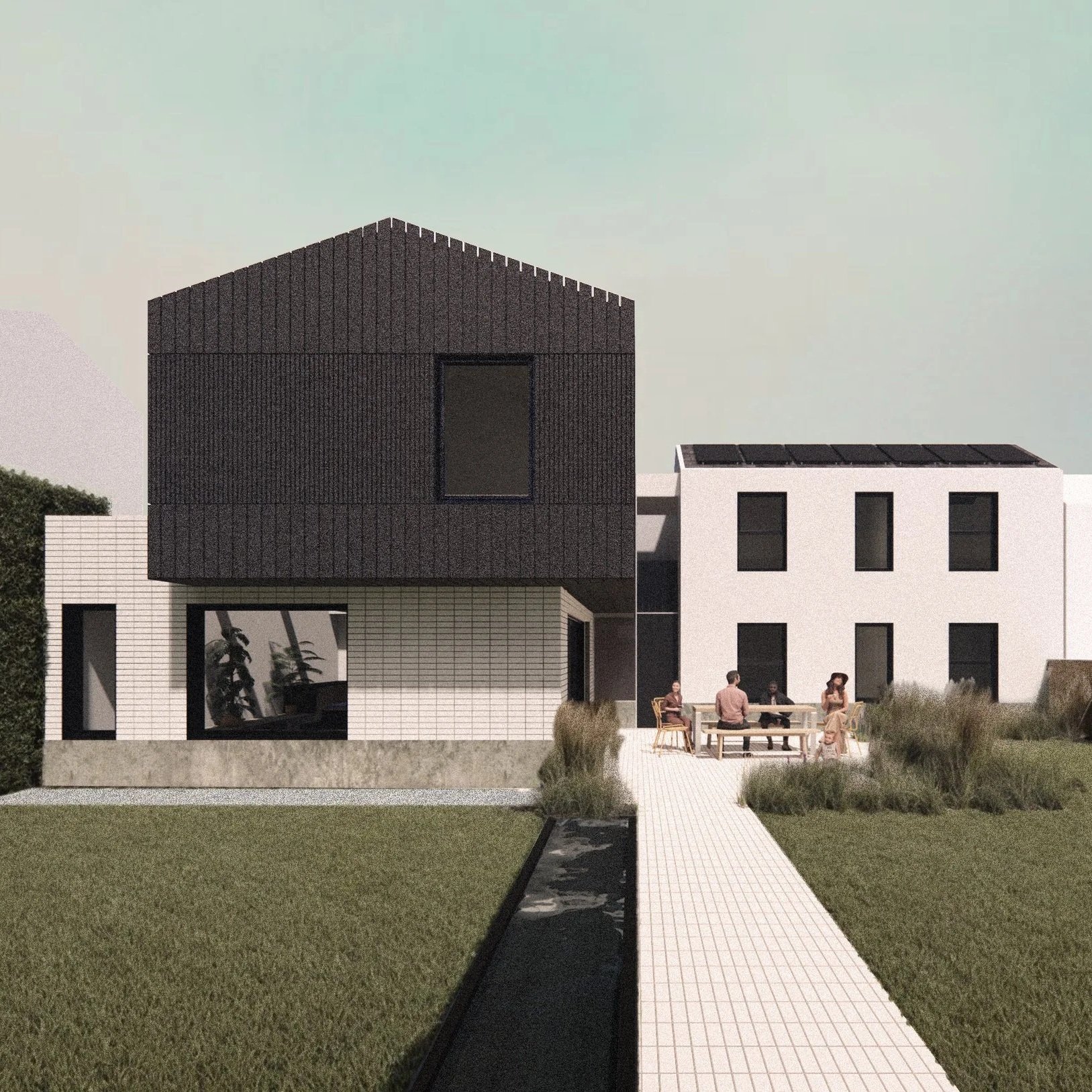 Modern multi-story house with white brick and black accents, outdoor patio with people sitting at a table, grassy yard, and a narrow water feature in the foreground.
