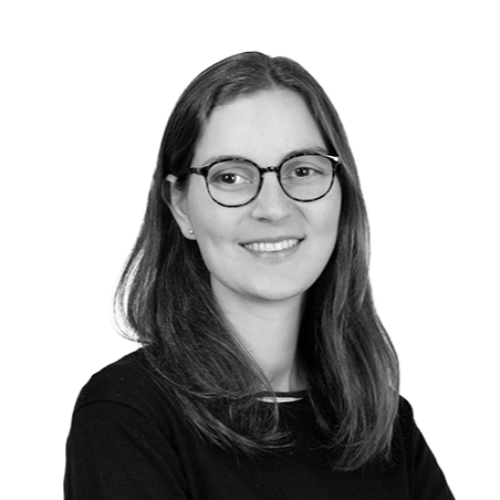 A young woman with shoulder-length hair, glasses, and a black top, smiling at the camera.