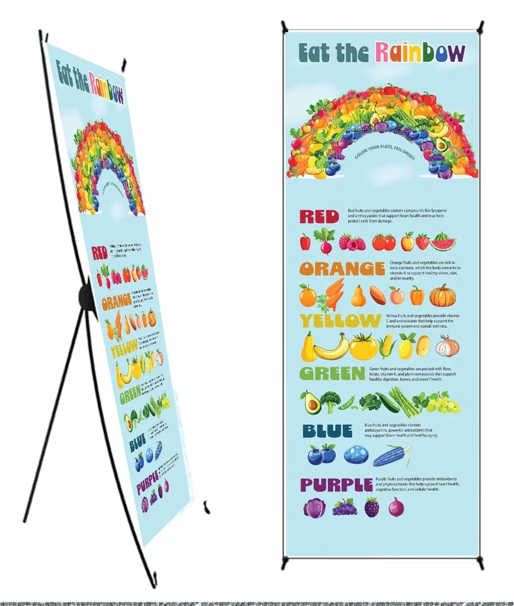 Educational banner titled "Eat the Rainbow" featuring a rainbow made of various colorful fruits and vegetables. It explains the health benefits of different colored foods: red, orange, yellow, green, blue, and purple, with corresponding images of fruits and vegetables and brief descriptions of their health benefits.