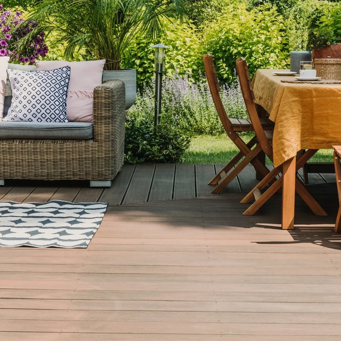 High-end outdoor patio on a custom wood deck in a lush San Diego backyard, showcasing premium craftsmanship and outdoor living design.