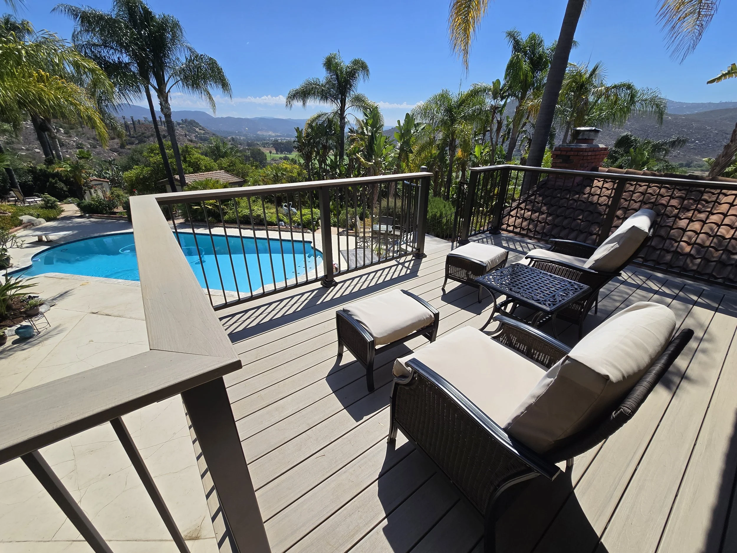 Second-story composite deck installation designed for view enhancement and structural durability.