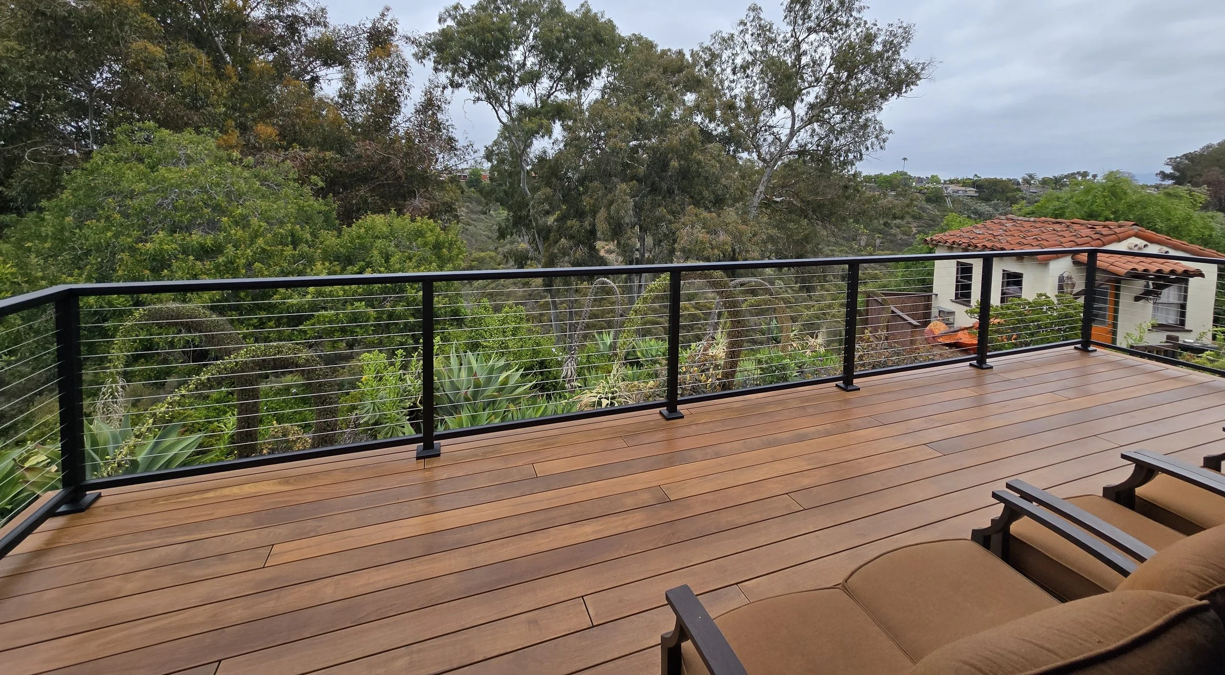 Custom Ipe hardwood deck with Feeney Design cable railing system installed by licensed deck builder in San Diego County