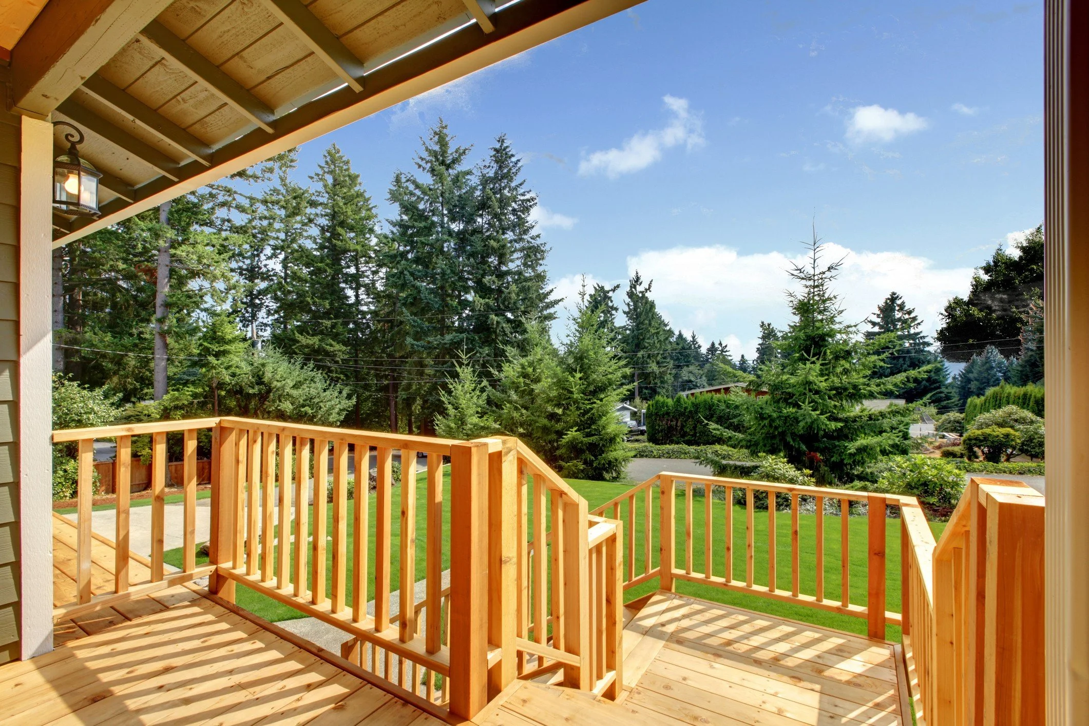 Custom wood railing on wood deck featuring installation designed for safe outdoor living and architectural consistency.