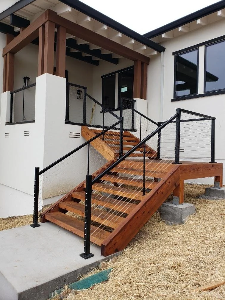 Custom redwood staircase featuring a Feeney CableRail system for an unobstructed coastal view in San Diego.