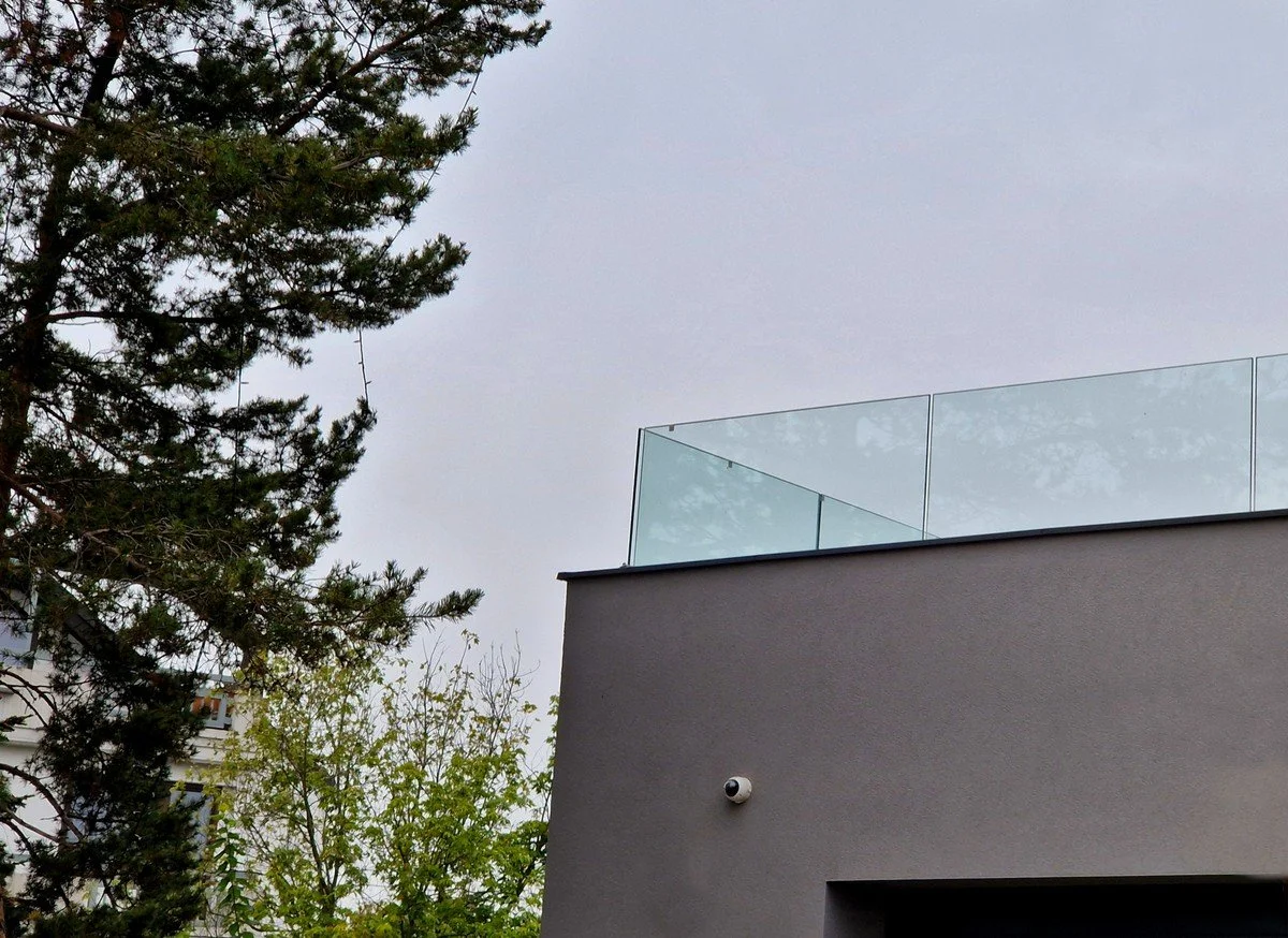 Elevated deck featuring frameless glass rail installation designed for view preservation and modern outdoor living use.