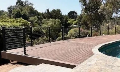 Feeney cable rail custom fit around deck pool built by Picano Builders.