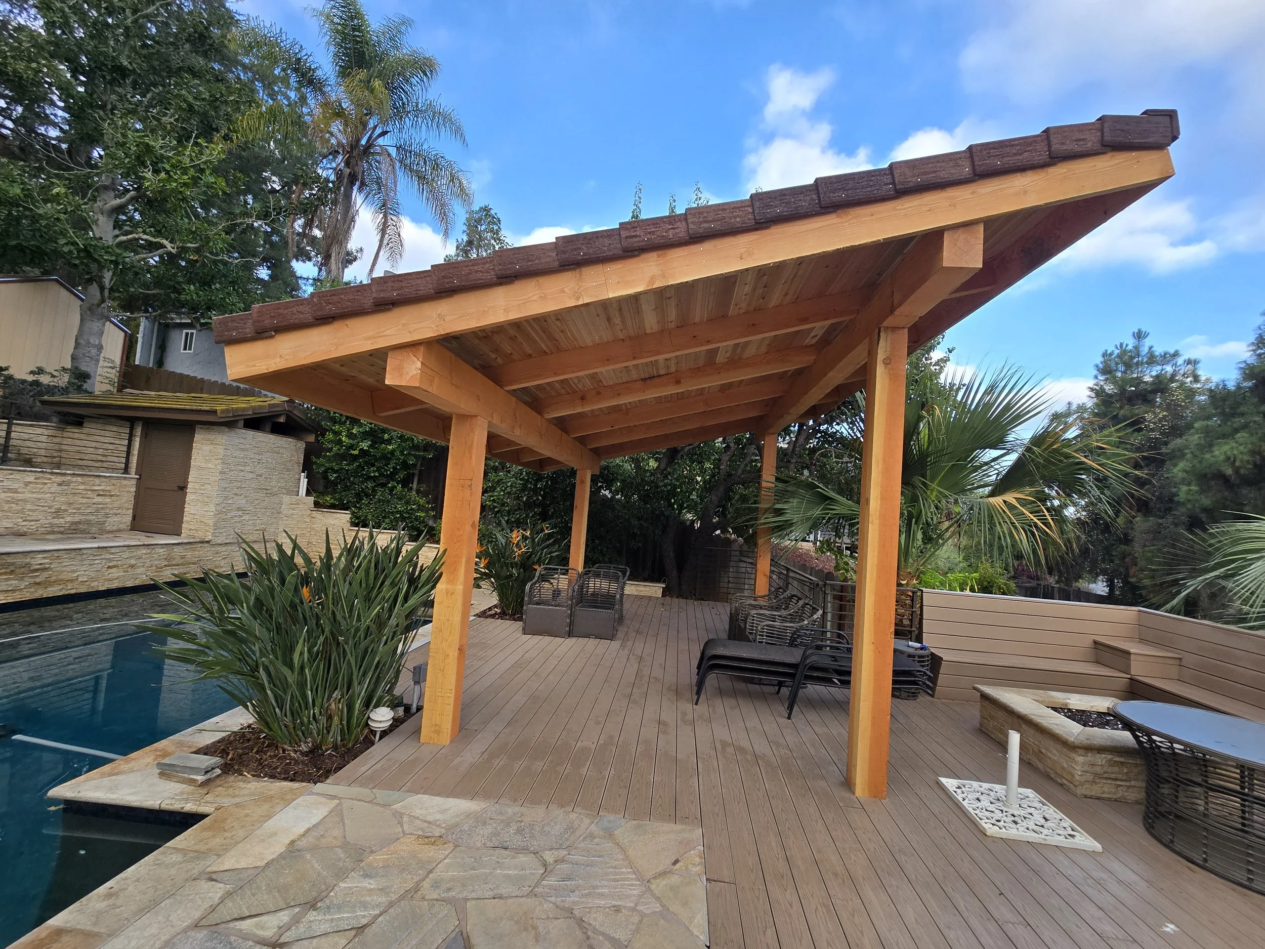 Custom wood pergola installed over composite deck for shade and structural outdoor living enhancement in San Diego County